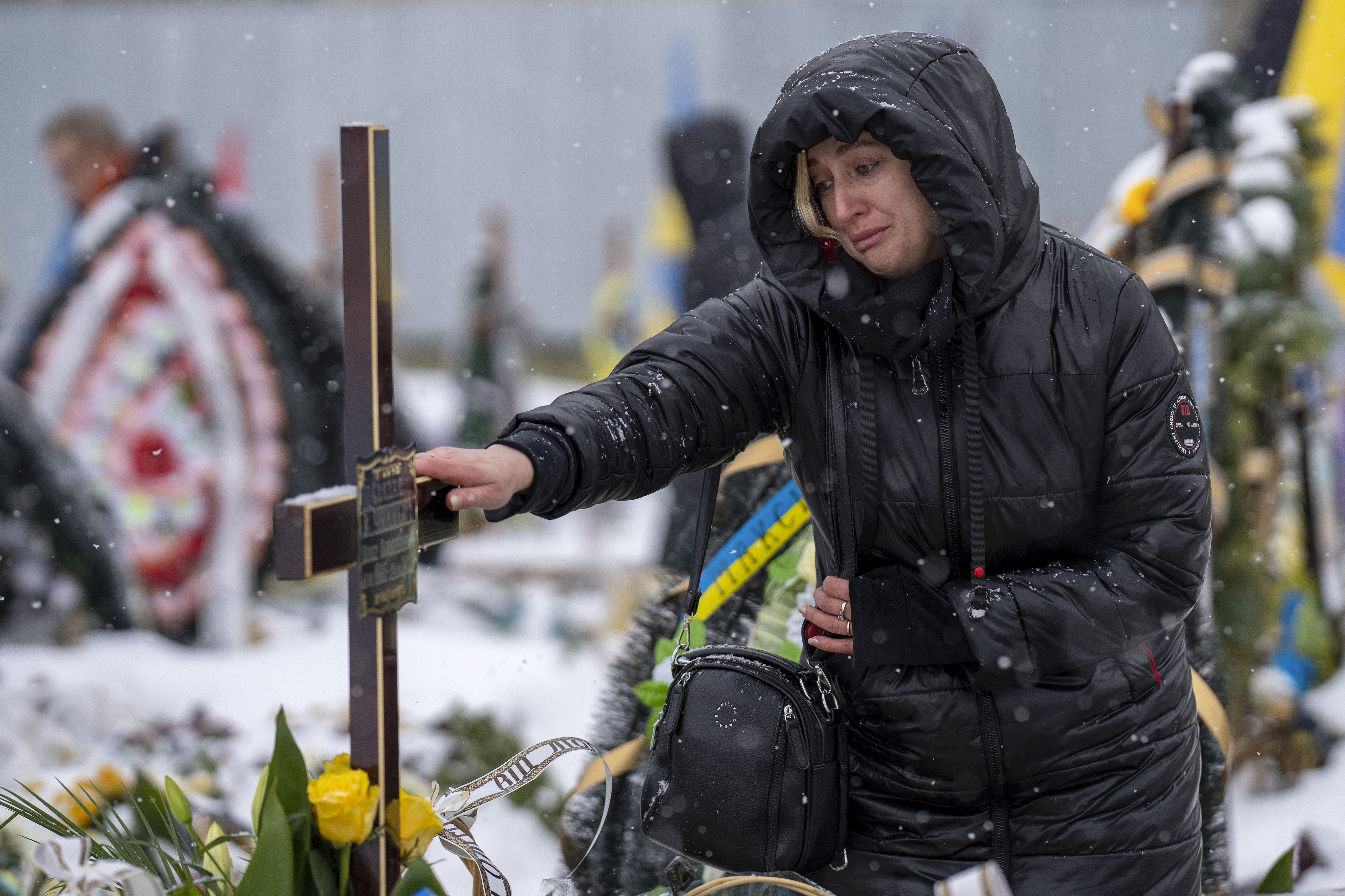Nataliya cries at the grave of her brother Oleg Kunynets, a Ukrainian soldier who was killed in the east of the country
