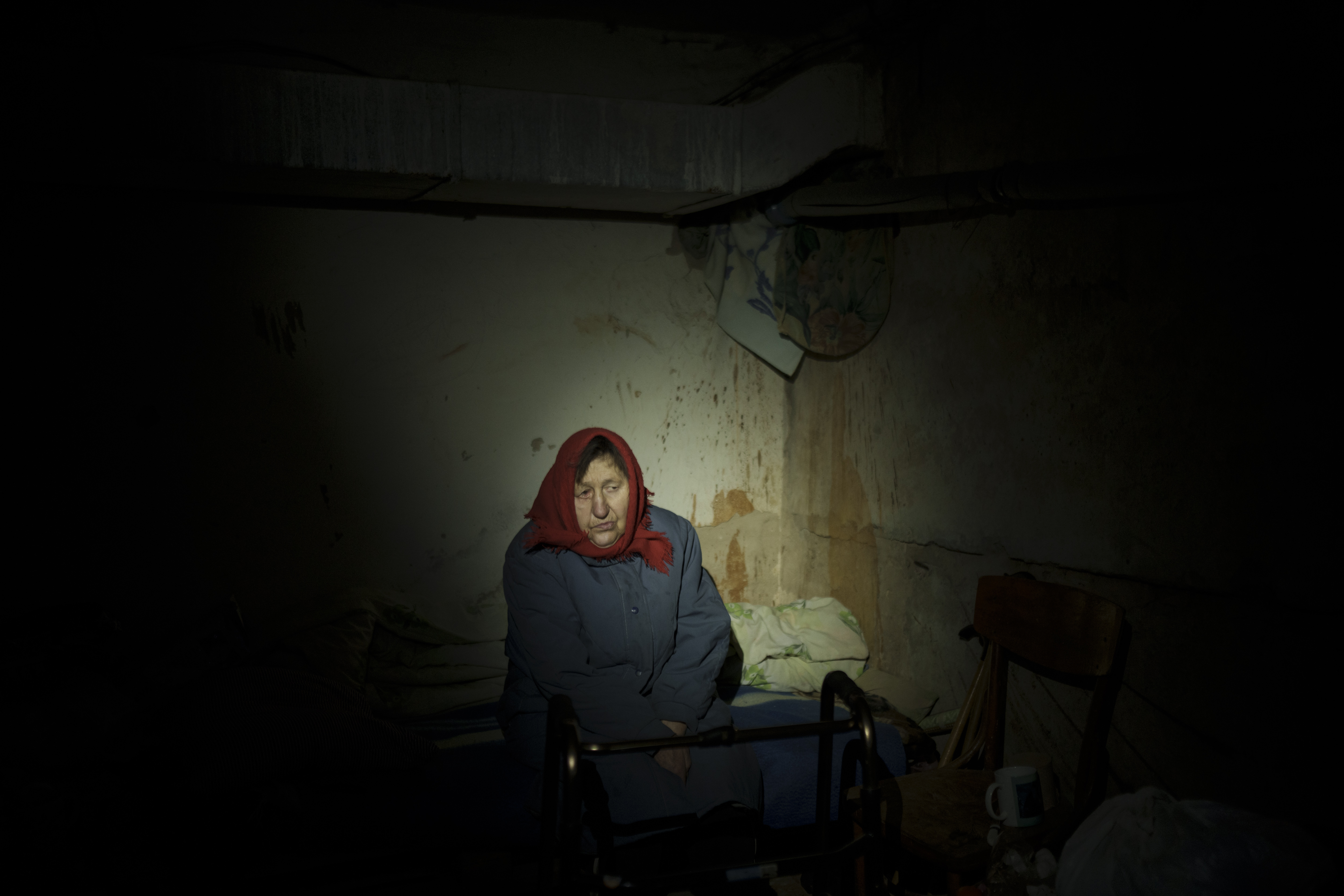 A woman takes shelter in a basement with no electricity in Irpin, on the outskirts of Kyiv