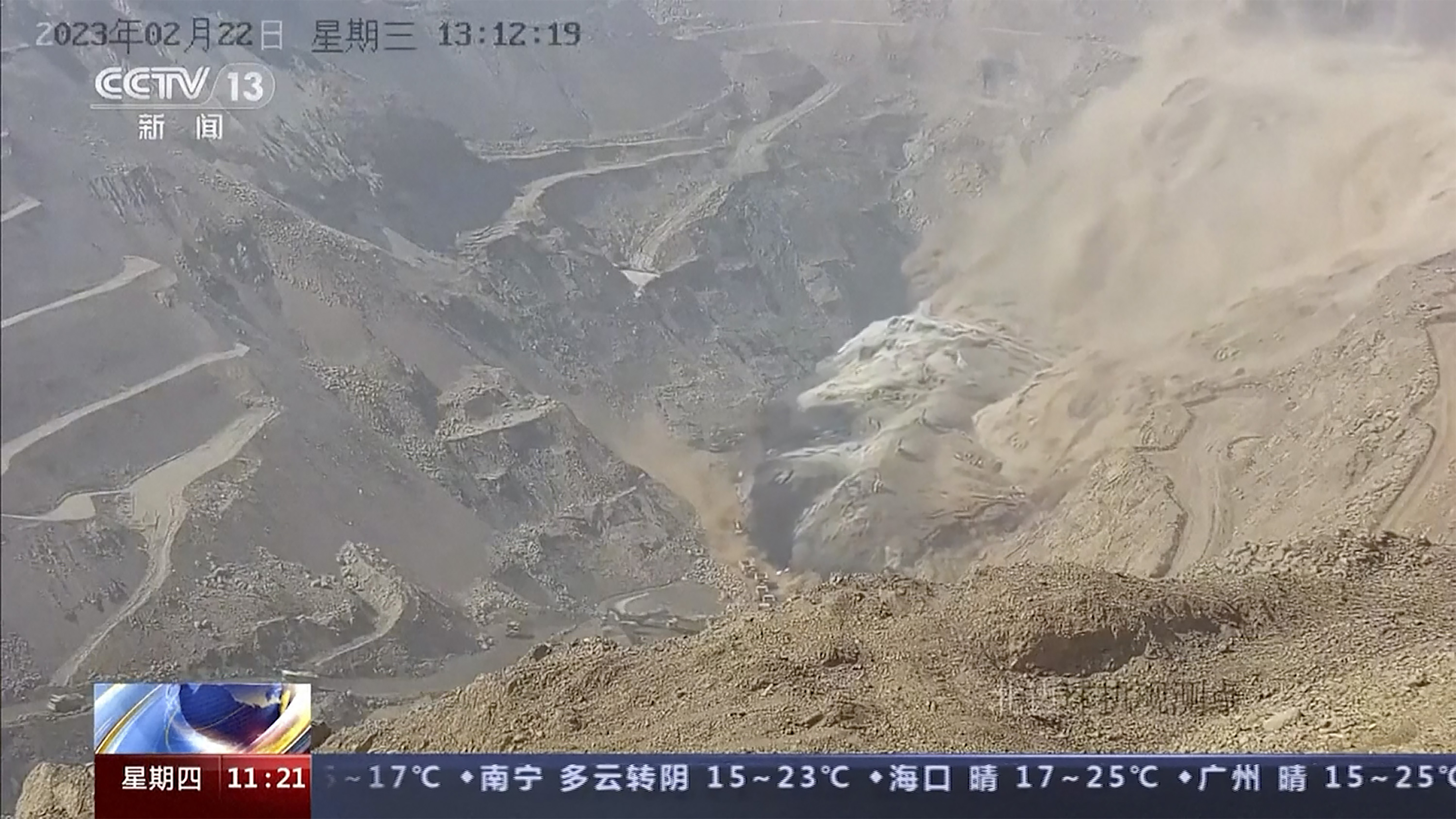 In this image taken from official surveillance camera footage run by China’s CCTV, dirt moves down the side of a hill at an opencast mine in Alxa League in the Inner Mongolia autonomous region [CCTV via AP]