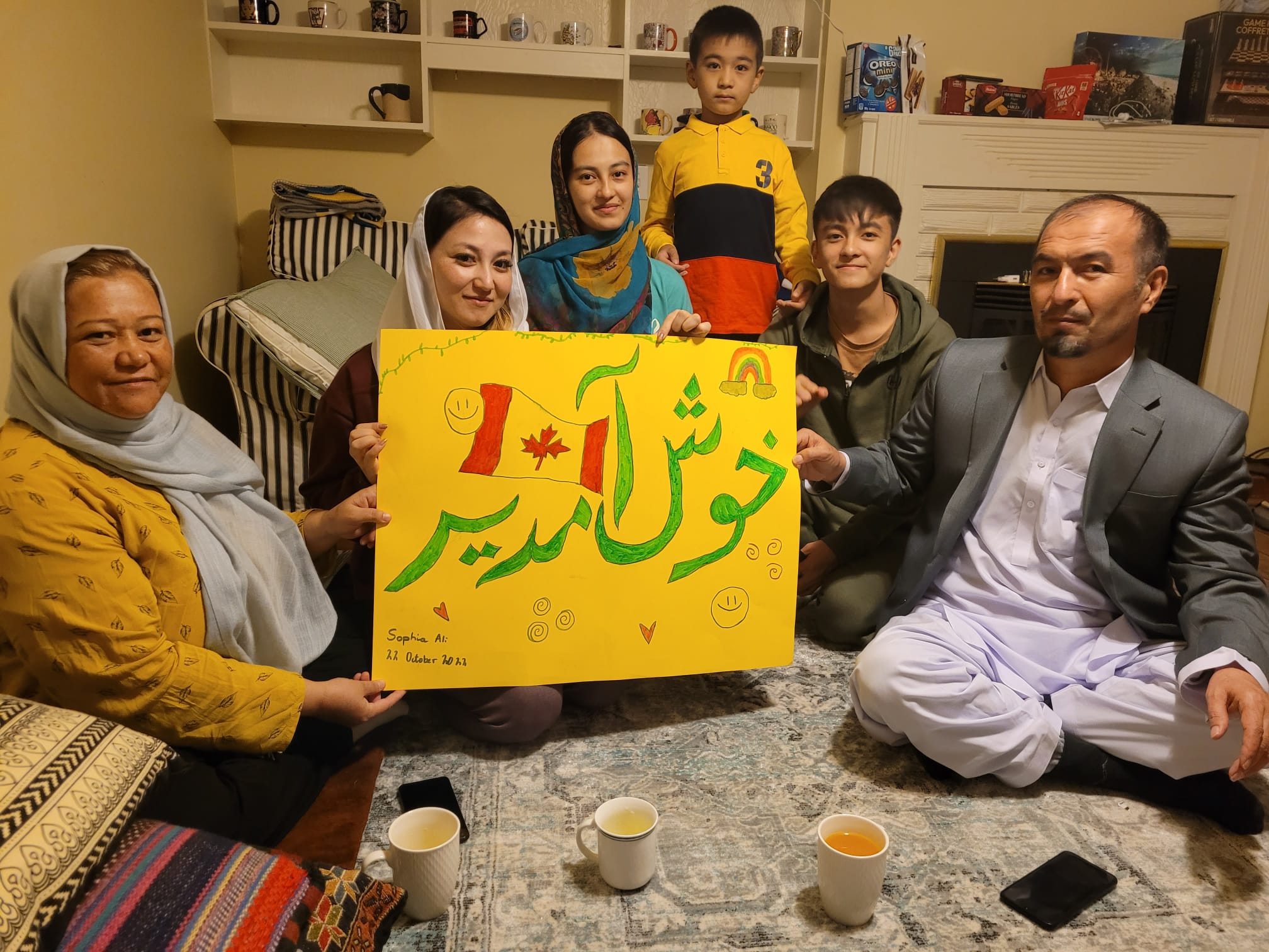A photo of a group of people holding a sign.