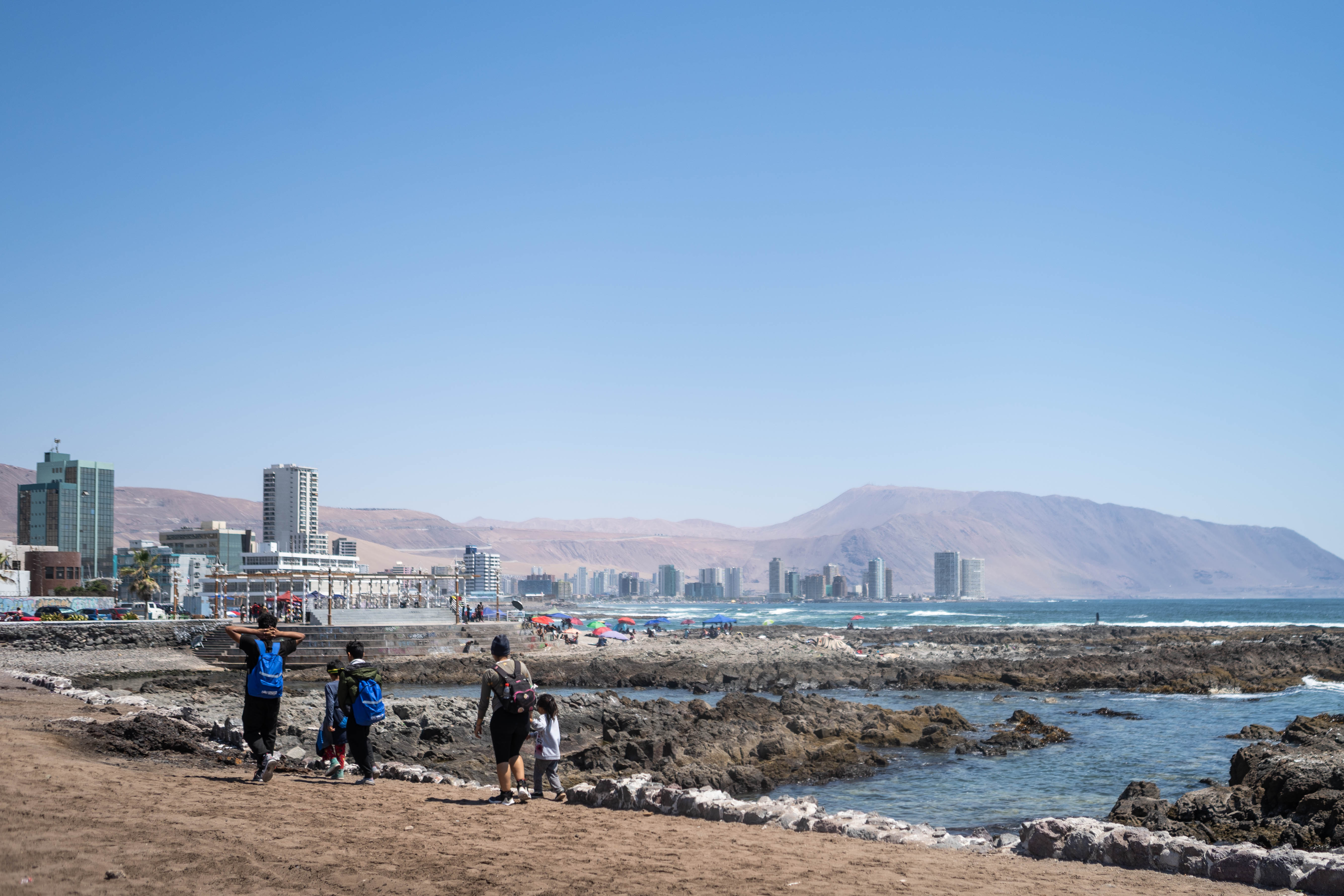 Allyson and her family walk along the shores in Iquique, Chile.