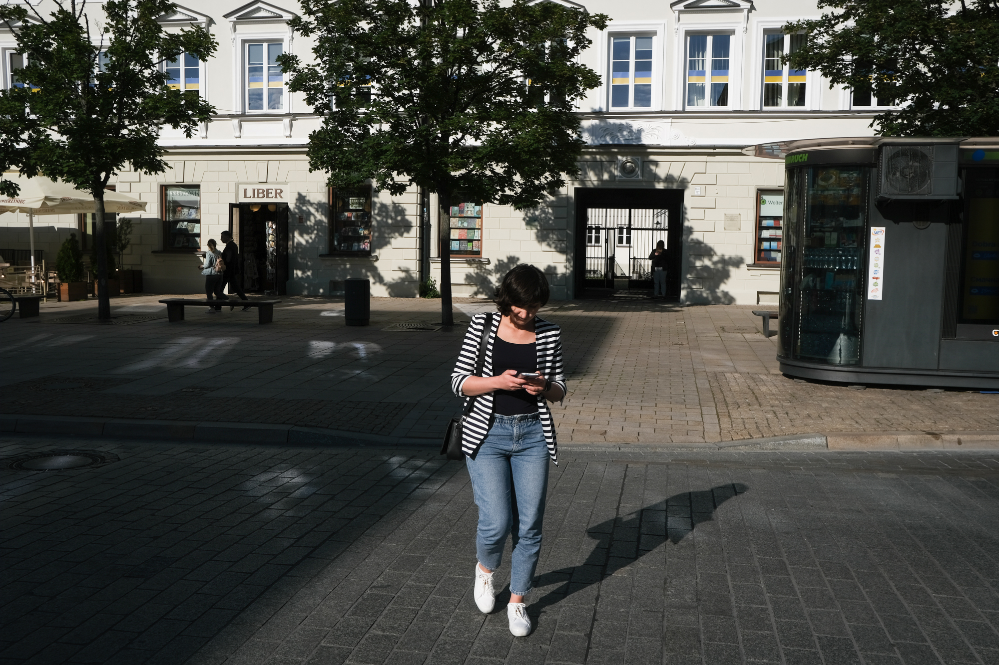 A photo of Zakhida standing in the middle of a street.