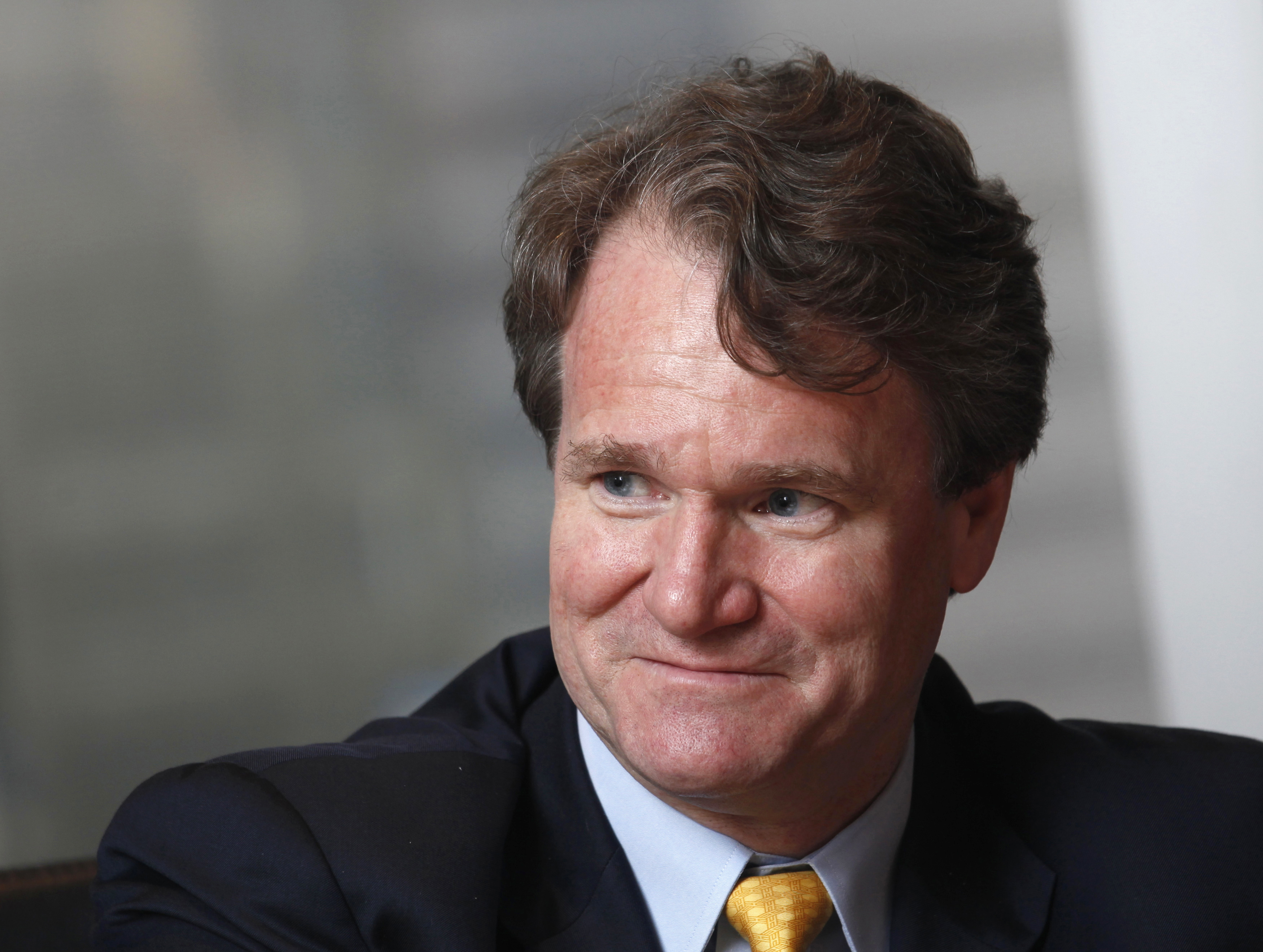 Bank of America Chief Executive Brian Moynihan smiles during an interview.