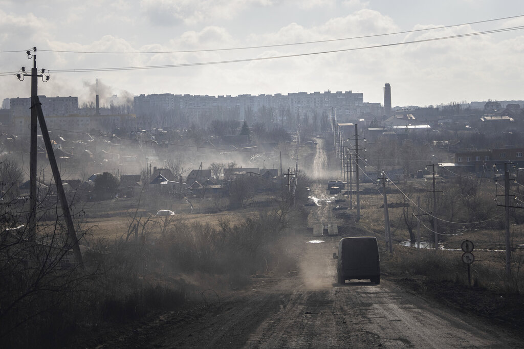 A Ukrainian police van drives on the highway for evacuation of civilians in Khromove near Bakhmut