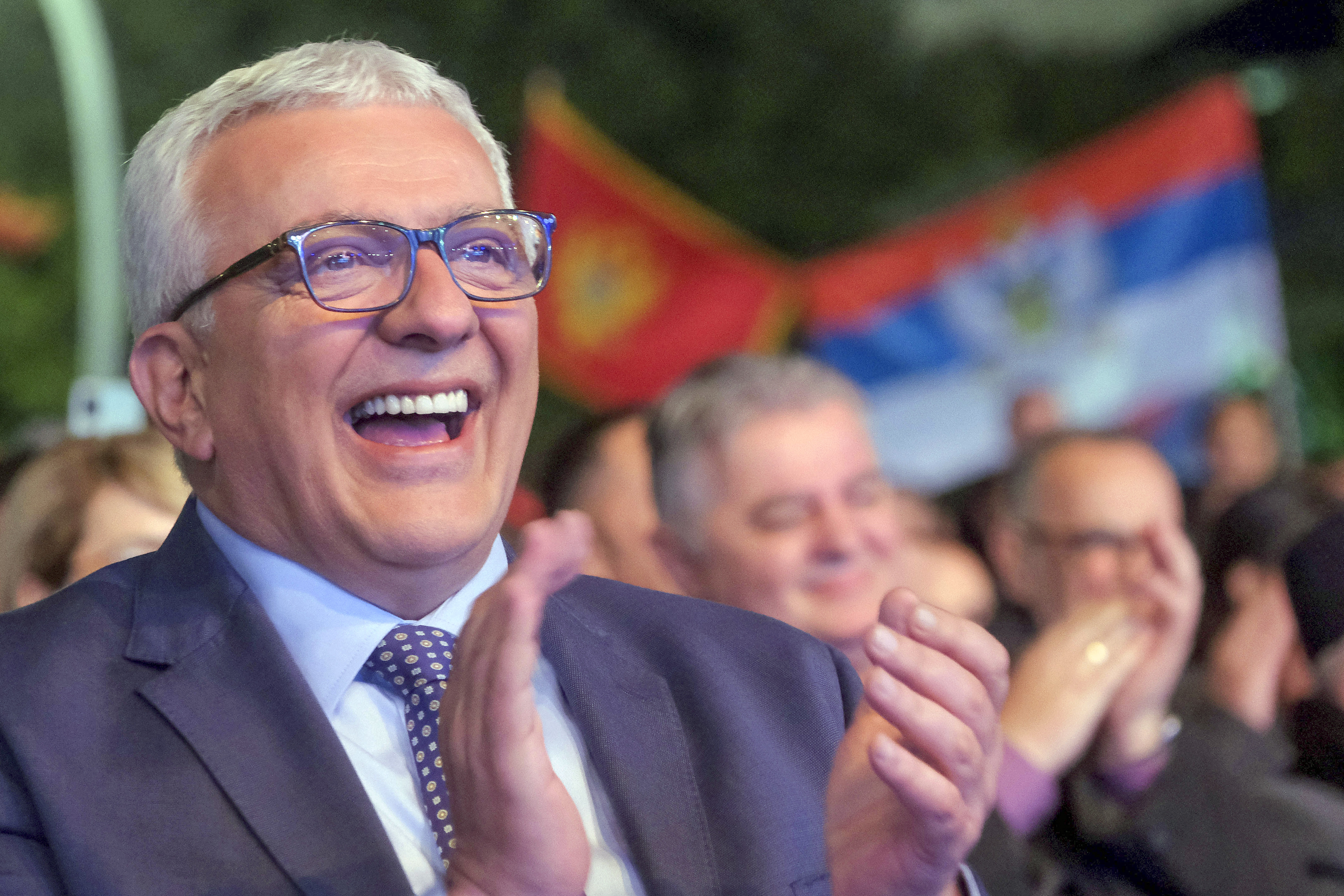 Popular Front party leader Andrija Mandic applauds during a pre-election rally in Podgorica, Montenegro, Friday, March 17, 2023. Montenegro is holding a presidential election this weekend that is seen as a test of whether the country will move forward toward European Union integration or closer to neighboring Serbia and Russia. (AP Photo/Risto Bozovic)