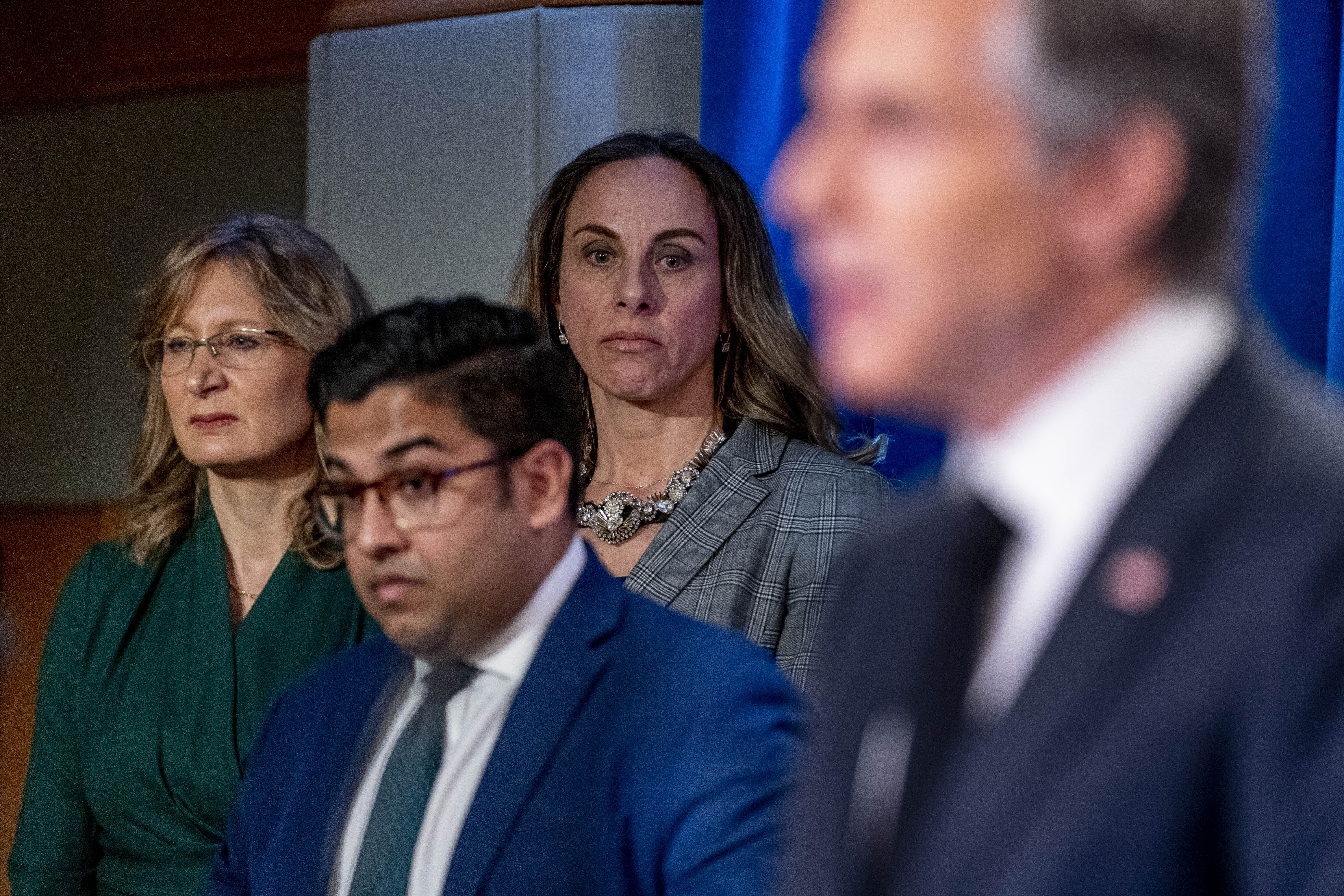 Vedant Patel stands between Erin Barclay and Beth Van Schaack at an Antony Blinken press conference