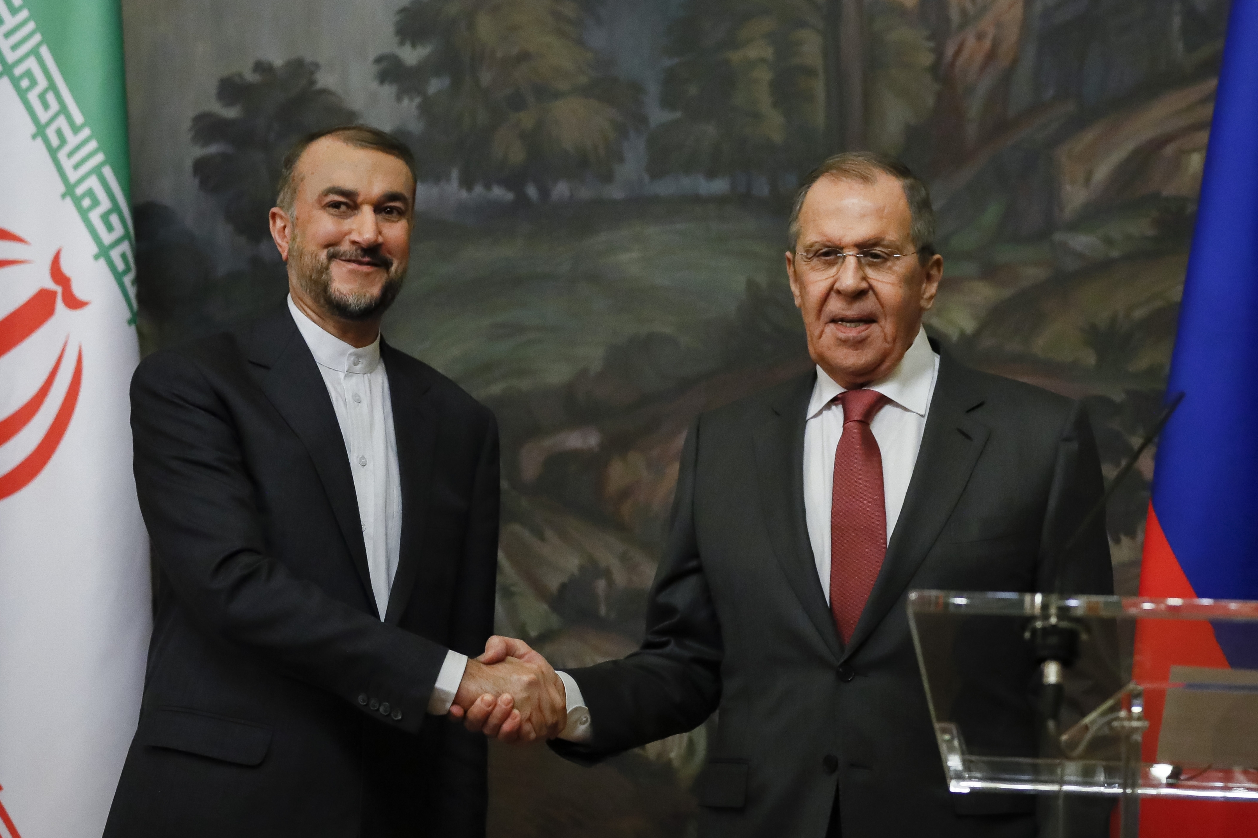 Russian Foreign Minister Sergey Lavrov, right, and Iranian Foreign Minister Hossein Amirabollahian shake hands