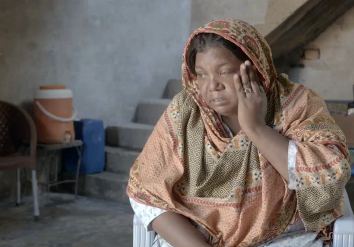 A photo of a woman with her hand on her face.