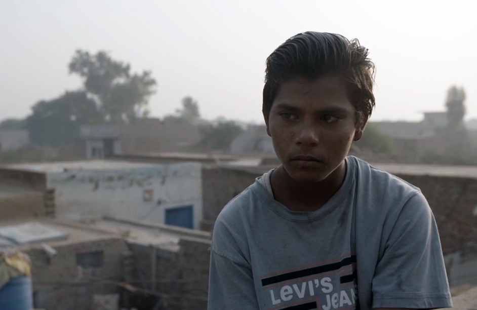 A photo of a person sitting outside.