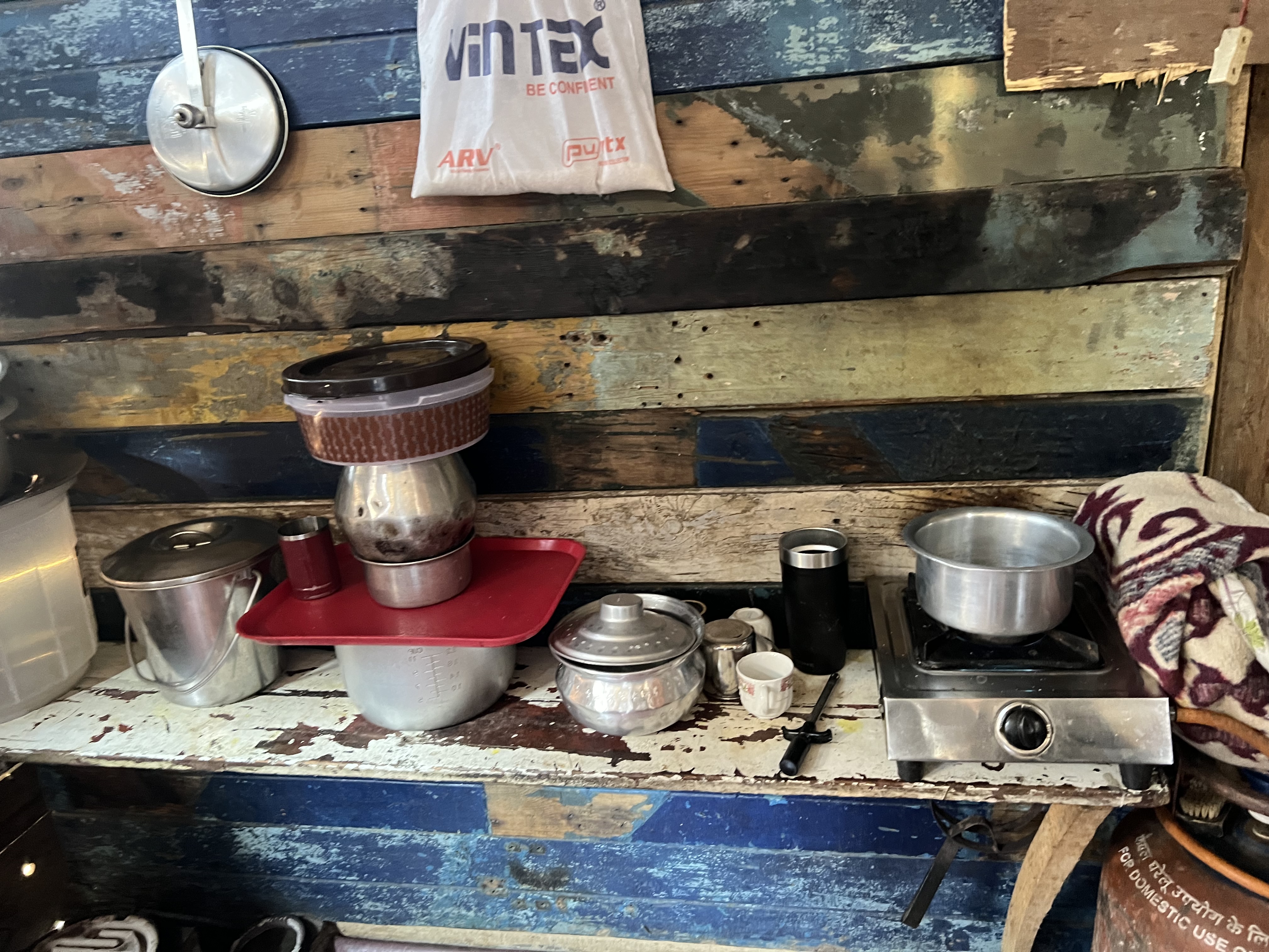 A wooden shelf serves as a cooking area in Haleema's kitchen [Al Jazeera]
