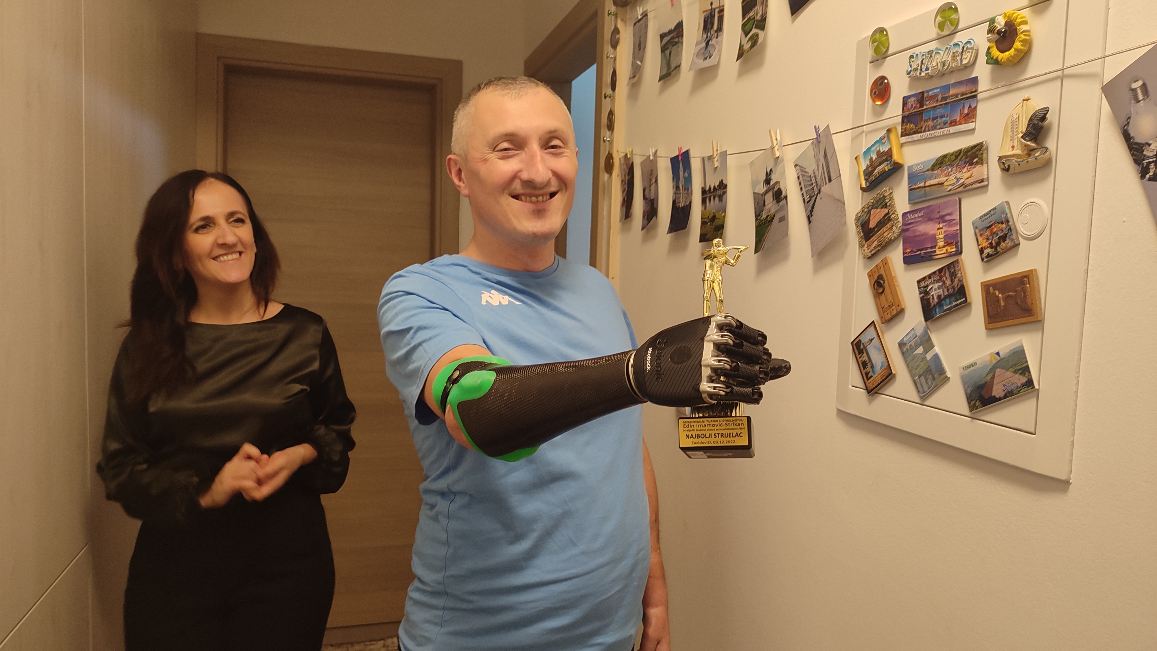 Rasim proudly shows off an award he received for sport shooting