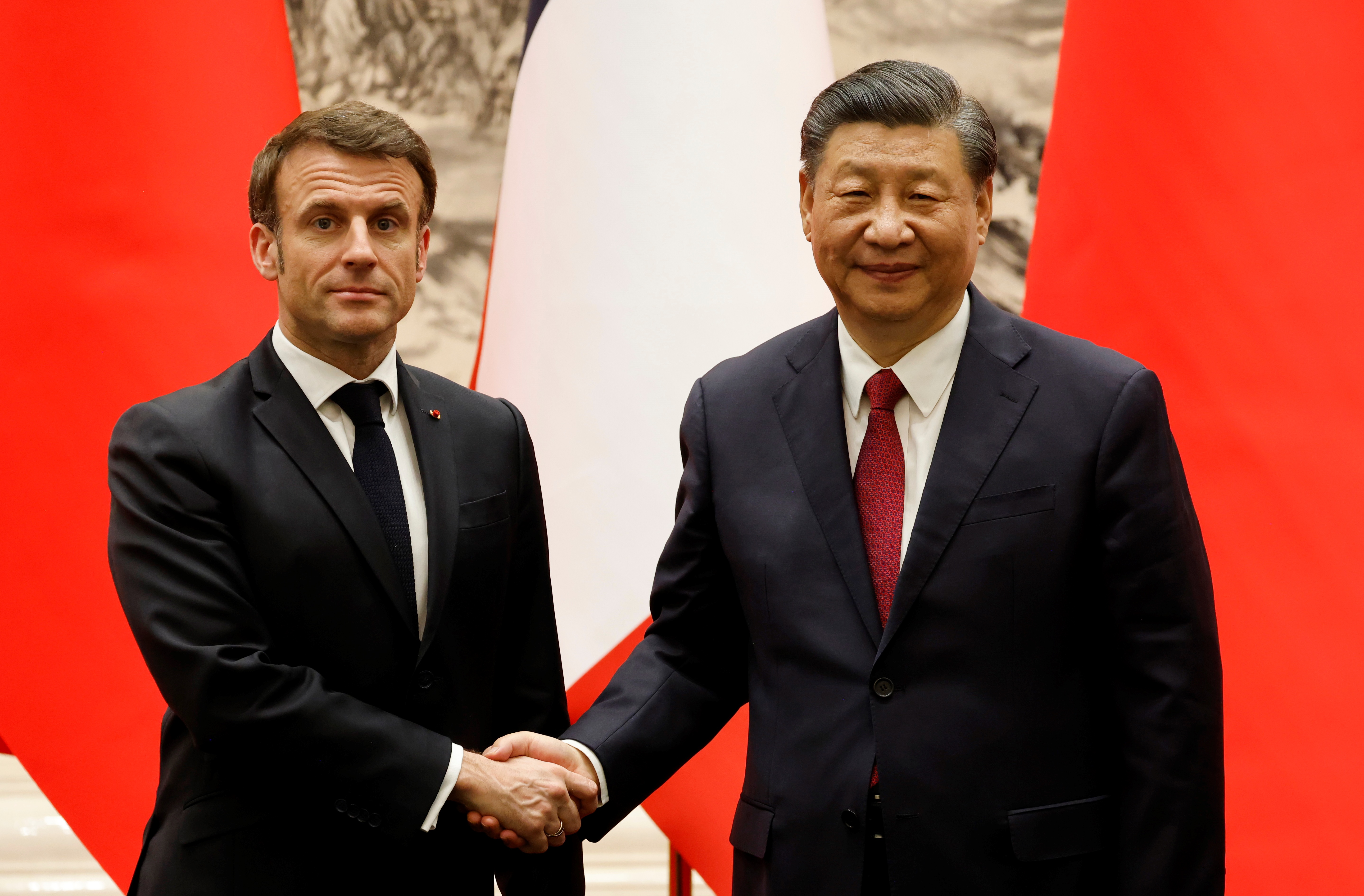 Chinas President Xi Jinping shakes hands with French President Emmanuel Macron