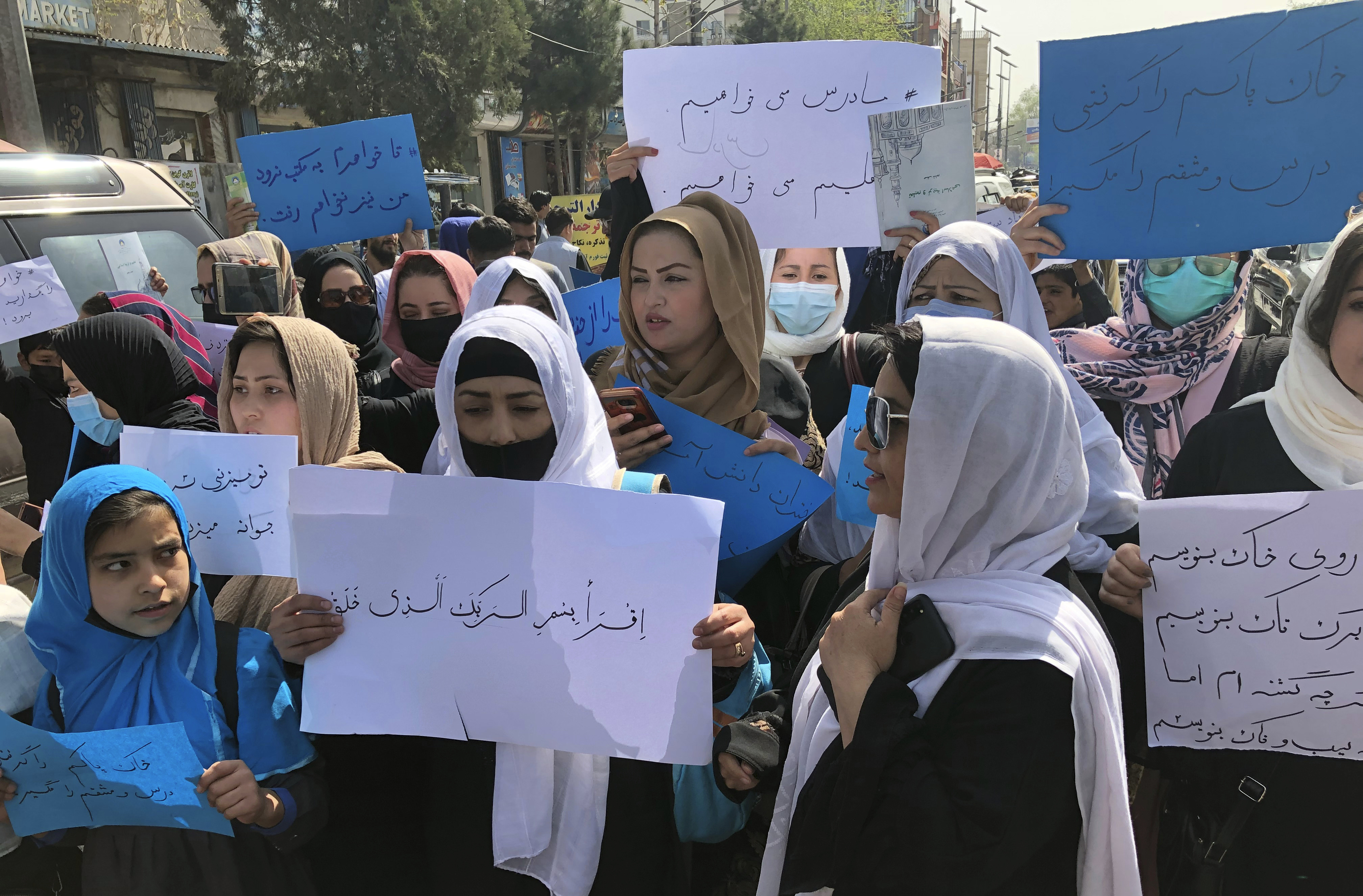 Afghan women chant and hold signs of protest during a demonstration in Kabul, Afghanistan