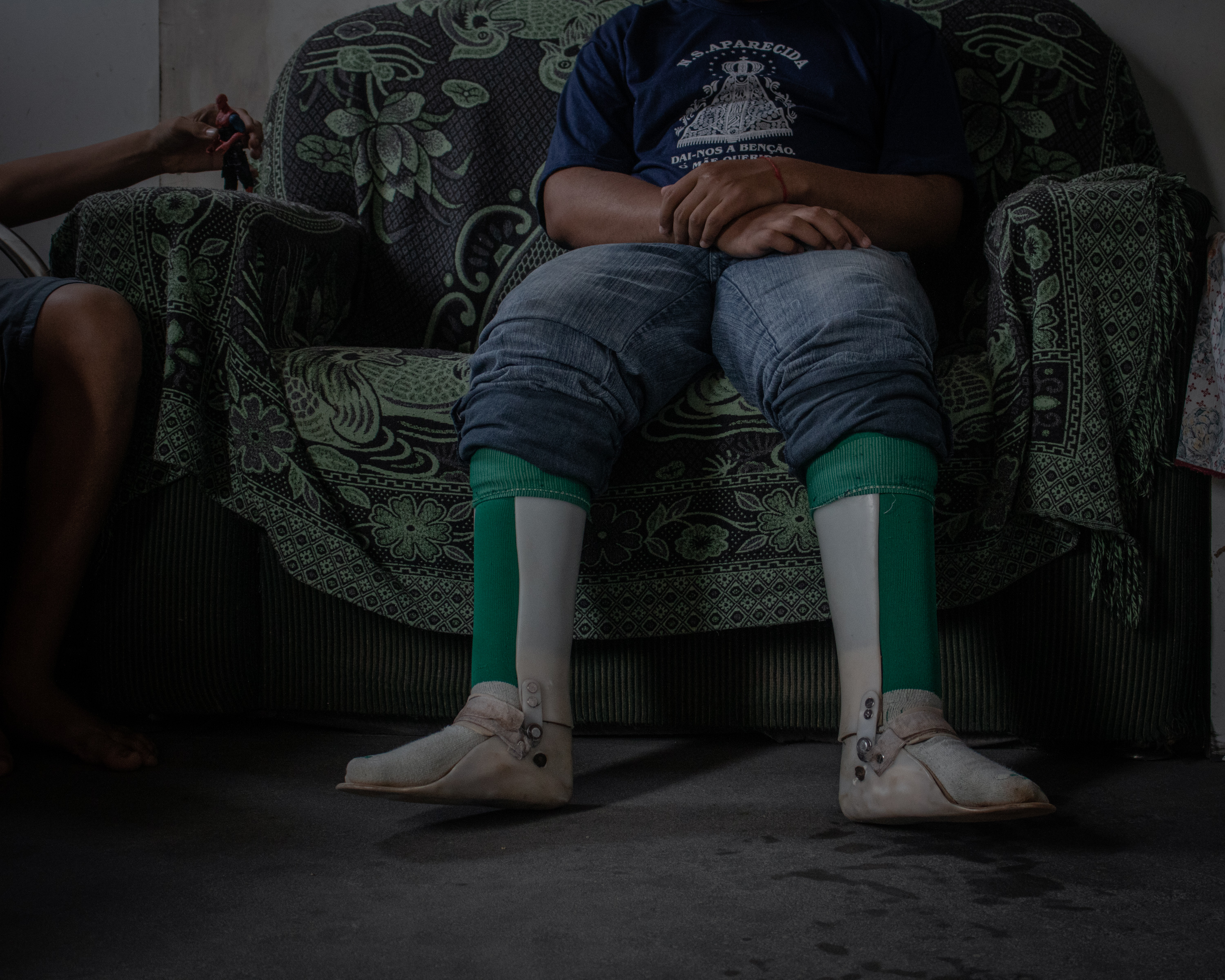 A photo of Cosme sitting on a sofa.