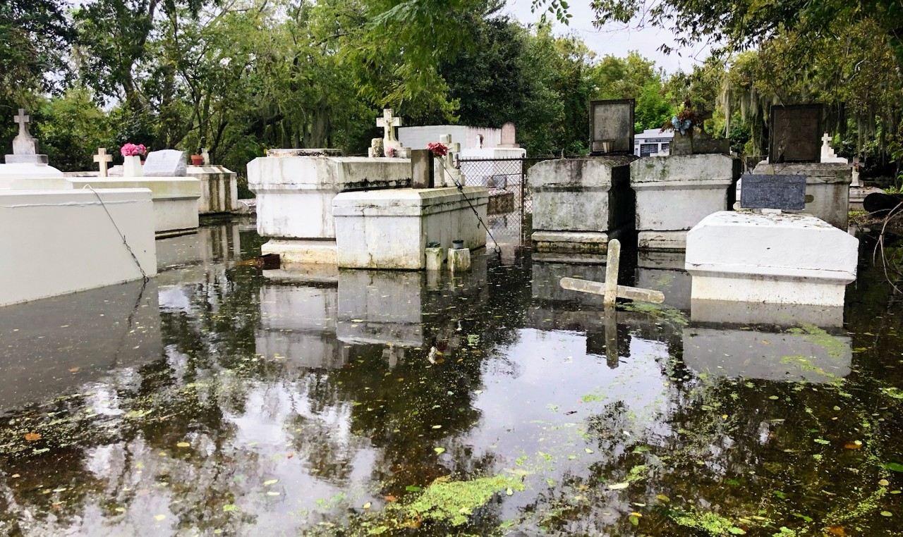 A photo of flooded gravestones and tombstones.