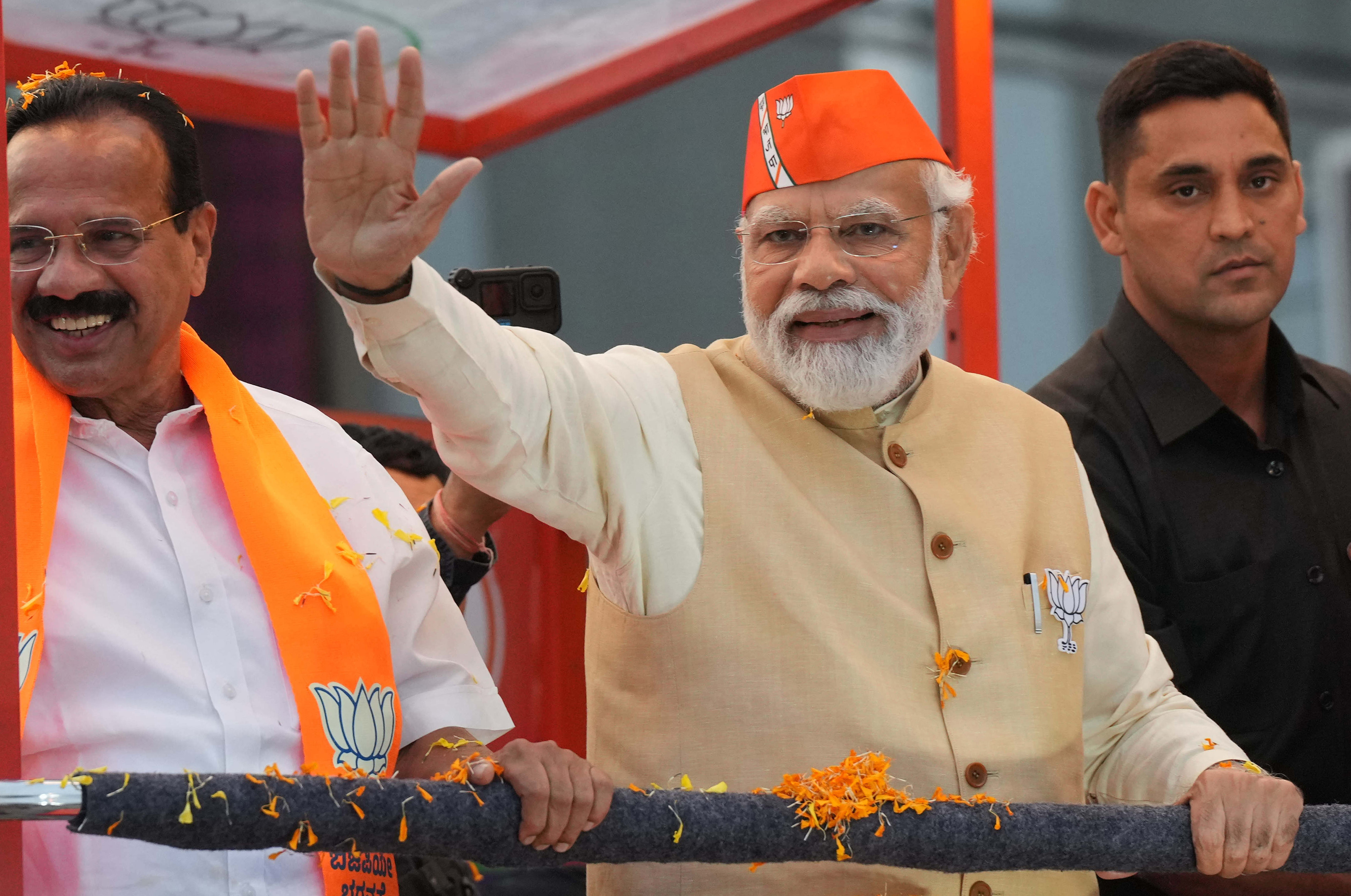 Modi gestures to the supporters during an election campaign in Bengaluru