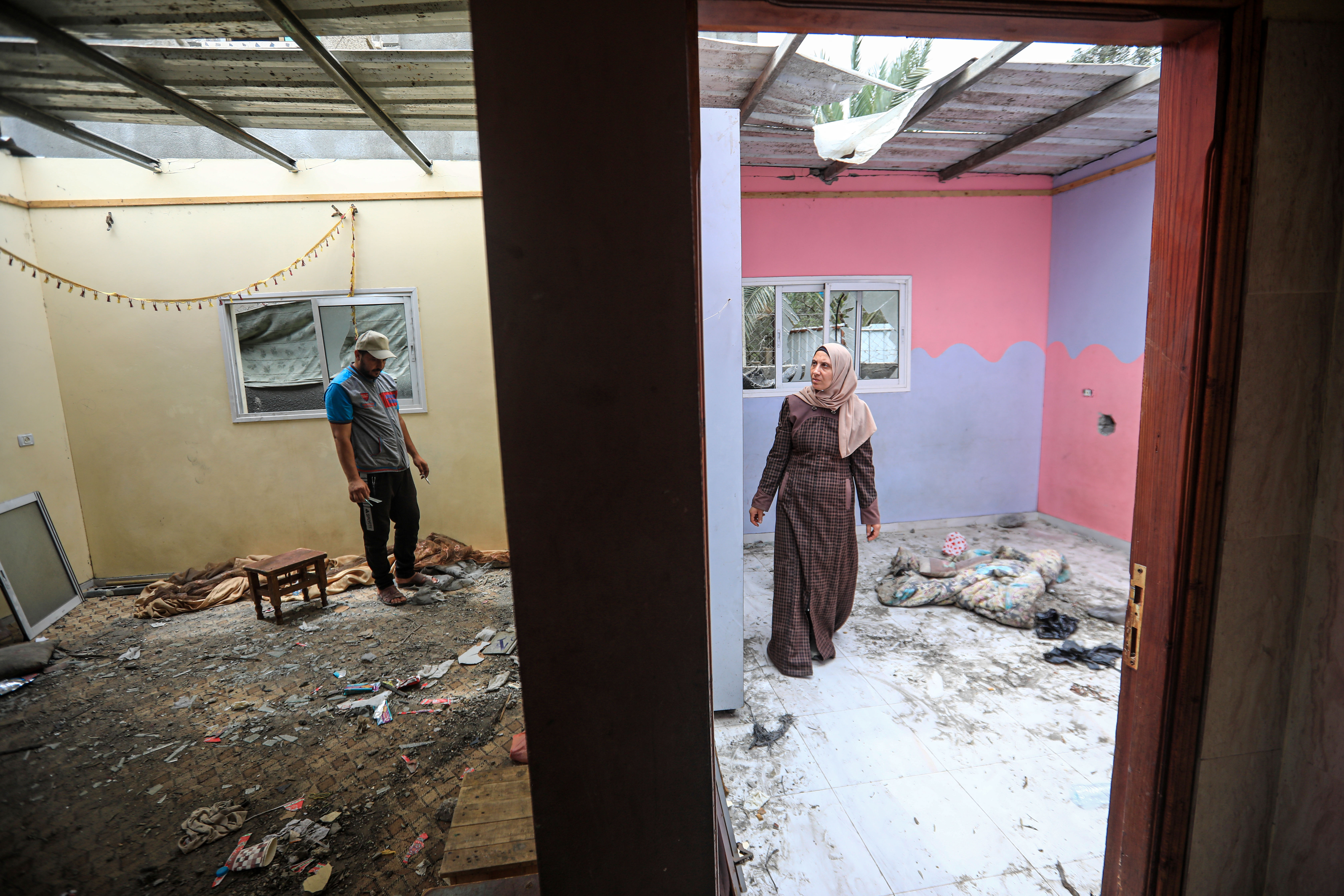 A man and his wife in their destroyed home