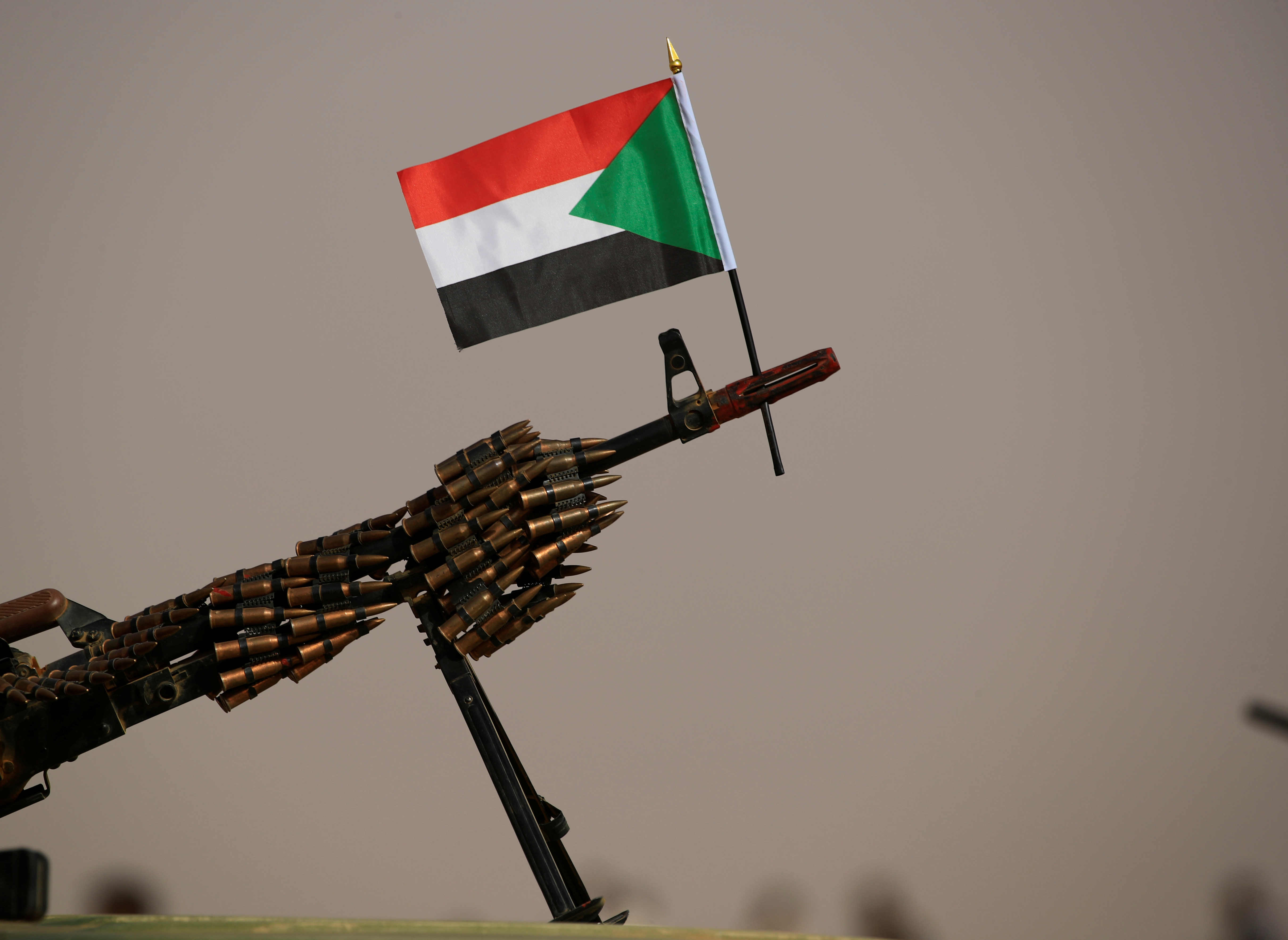 A Sudanese national flag is attached to a machine gun of RSF soldiers