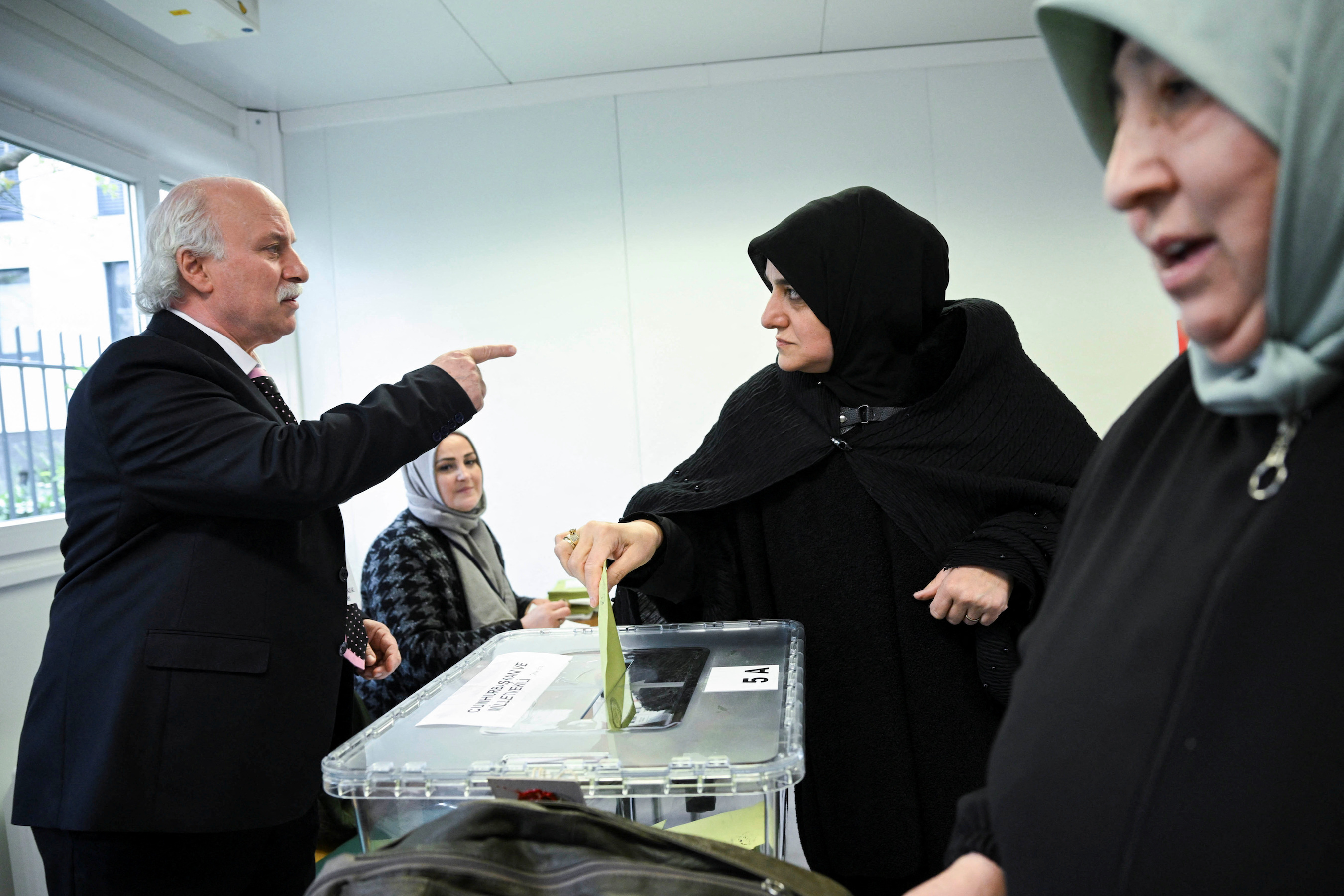A woman, who is a Turkish citizen living in Germany, casts her ballot for May 14 parliamentary and presidential election, at the Turkish Consulate of Berlin, in Berlin, Germany