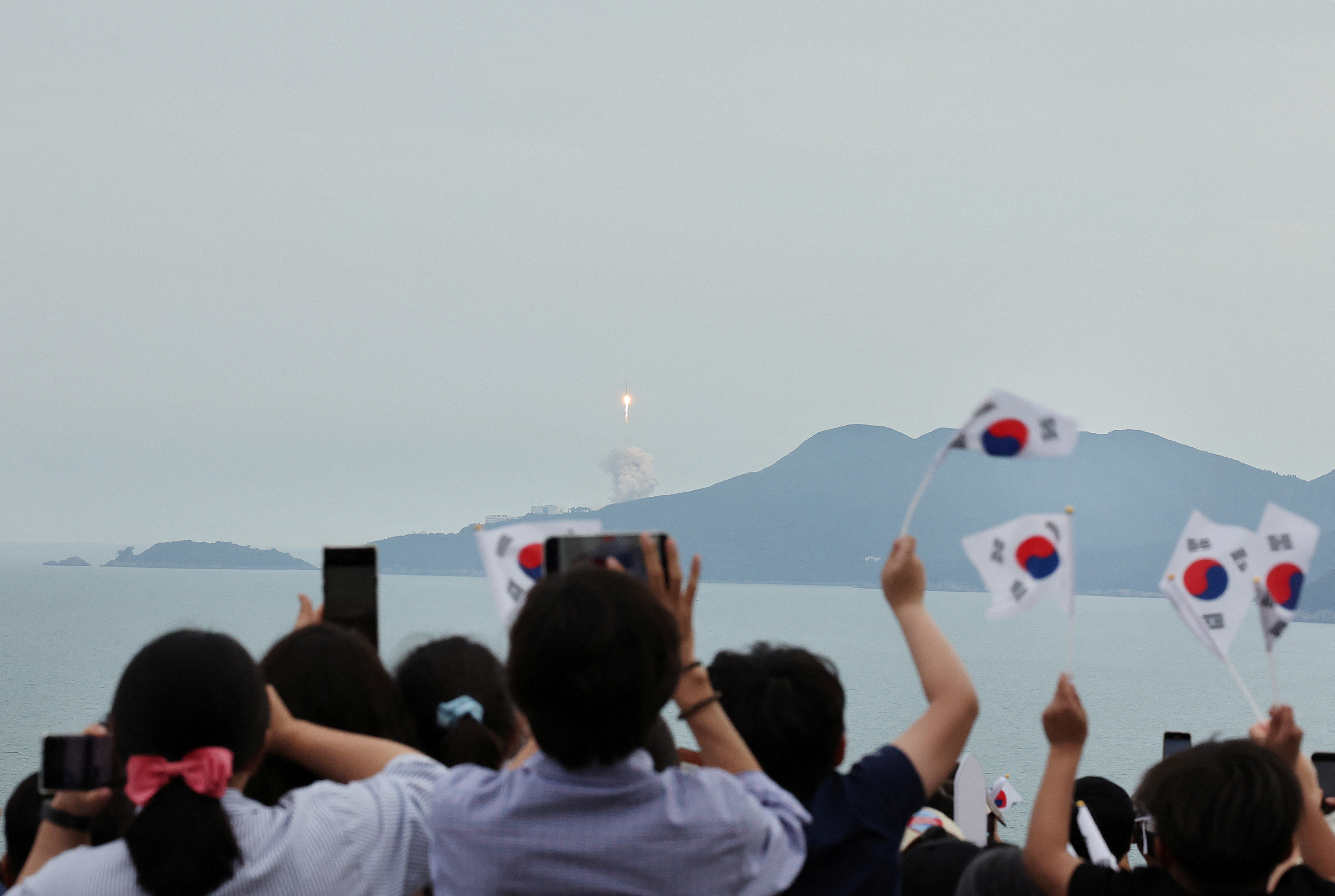 People watch the launch of South Korea’s homegrown Nuri space rocket in Goheung, South Korea May 25