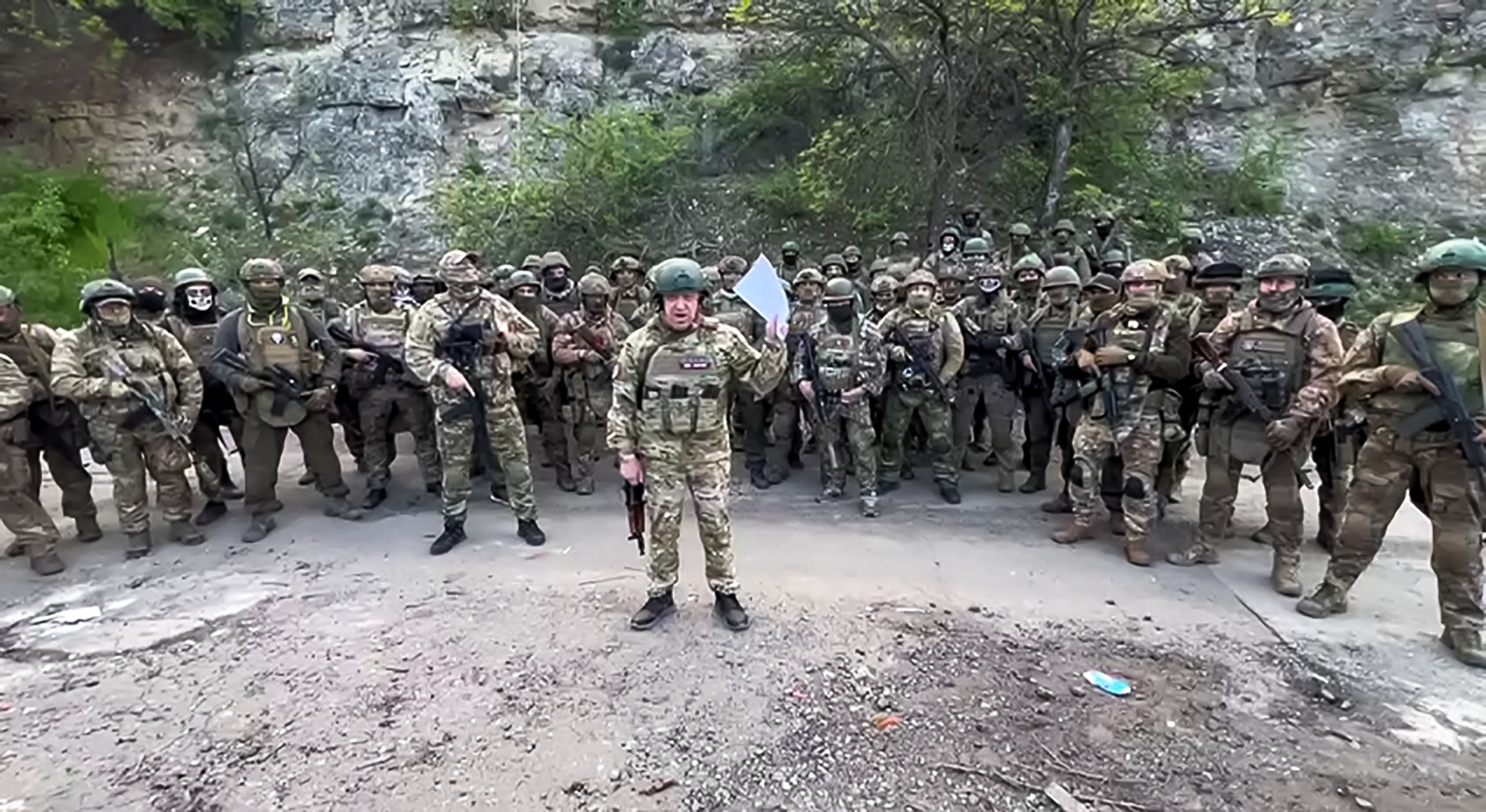 This video grab taken from a handout footage posted on May 5, 2023 on the Telegram account of the press-service of Concord -- a company linked to the chief of Russian mercenary group Wagner, Yevgeny Prigozhin -- shows Yevgeny Prigozhin addressing the Russian army's top brass standing in front of Wagner fighters at an undisclosed location. - The head of Russian paramilitary group Wagner on Friday threatened to pull his fighters from the front line in Bakhmut in eastern Ukraine on May 10, saying ammunition shortages meant they faced "senseless death". "On May 10, 2023 we will have to hand over our positions in Bakhmut to units of the defence ministry and withdraw Wagner units to rear camps to lick our wounds," Yevgeny Prigozhin said in a written statement on his Telegram channel. (Photo by Handout / TELEGRAM/ @concordgroup_official / AFP) / RESTRICTED TO EDITORIAL USE - MANDATORY CREDIT "AFP PHOTO / TELEGRAM CHANNEL OF CONCORD GROUP" - NO MARKETING - NO ADVERTISING CAMPAIGNS - DISTRIBUTED AS A SERVICE TO CLIENTS - RESTRICTED TO EDITORIAL USE - MANDATORY CREDIT "AFP PHOTO / Telegram channel of Concord group" - NO MARKETING - NO ADVERTISING CAMPAIGNS - DISTRIBUTED AS A SERVICE TO CLIENTS /