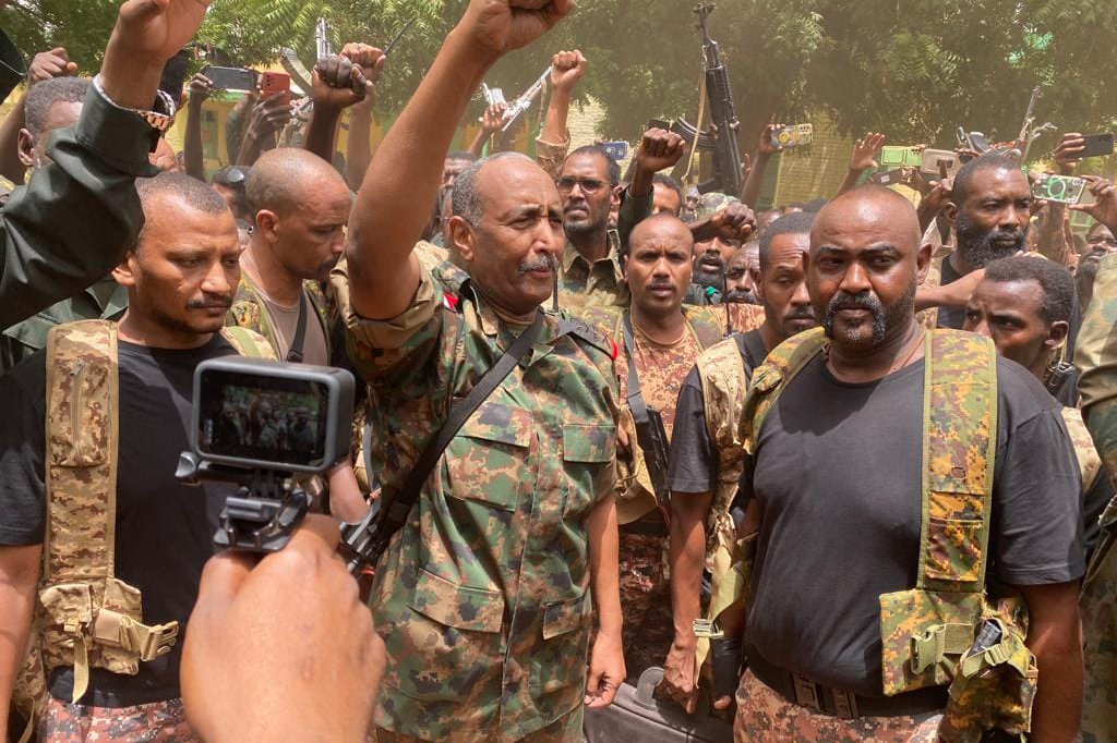 Army chief Abdel Fattah al-Burhan cheers with soldiers as he visits some of their positions in Khartoum.