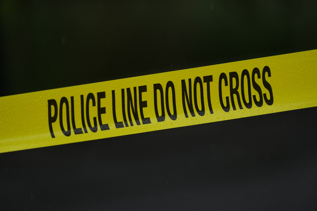 Police tape cordons off the scene.