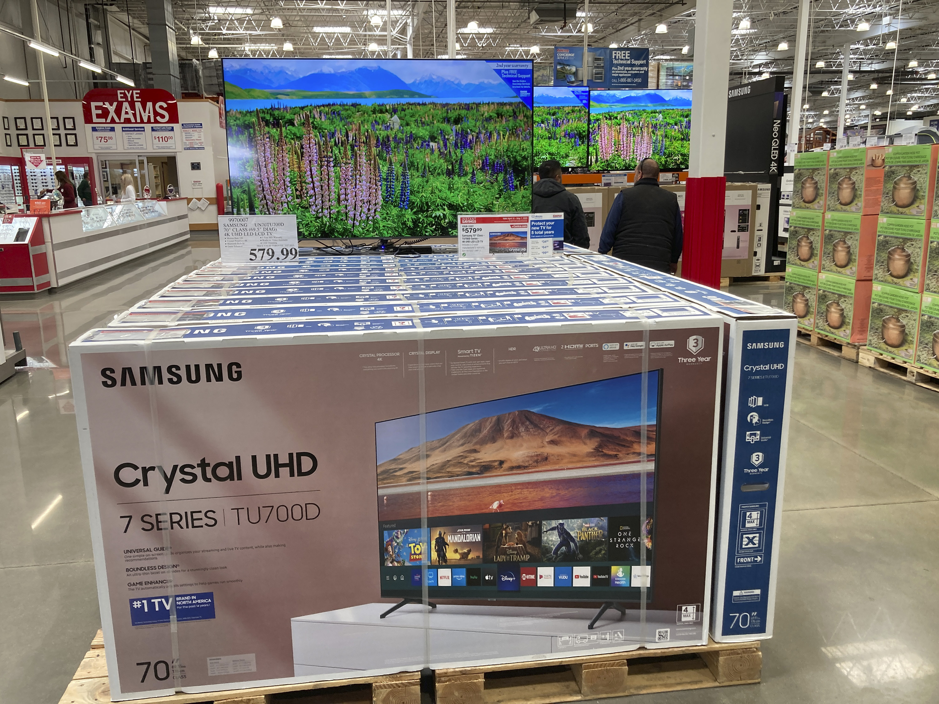 Shoppers pass by a display of big-screen televisions in a Costco warehouse in Colorado, US