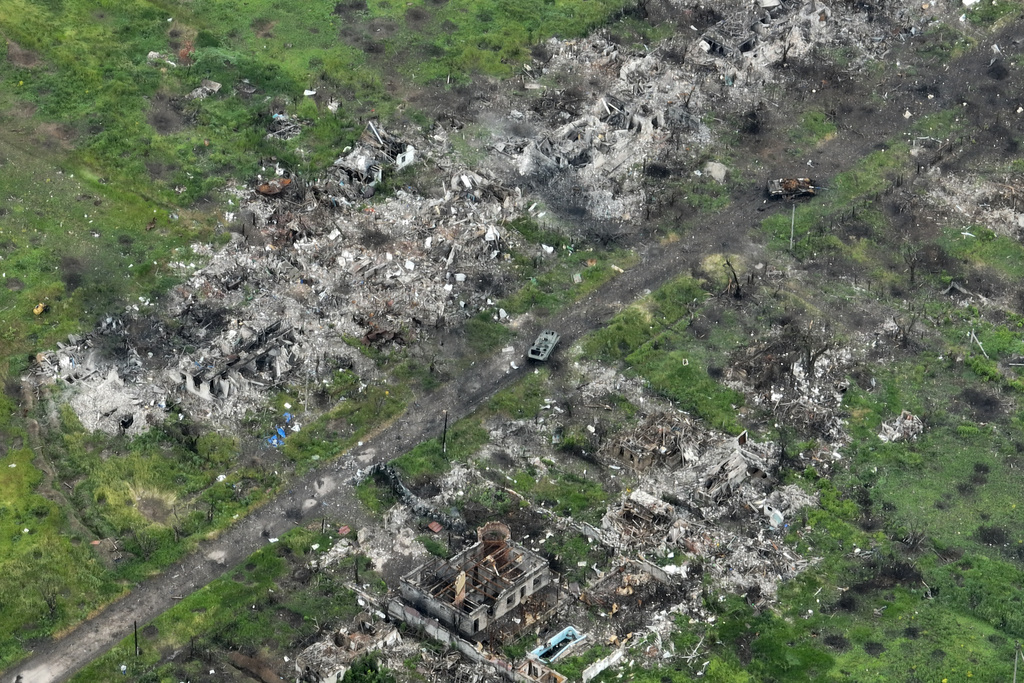 An aerial view of damaged private houses, shell and rocket craters in the suburbs of Donetsk, the site of fierce battles with the Russian forces, Ukraine, Friday, May 26, 2023. (AP Photo/Efrem Lukatsky