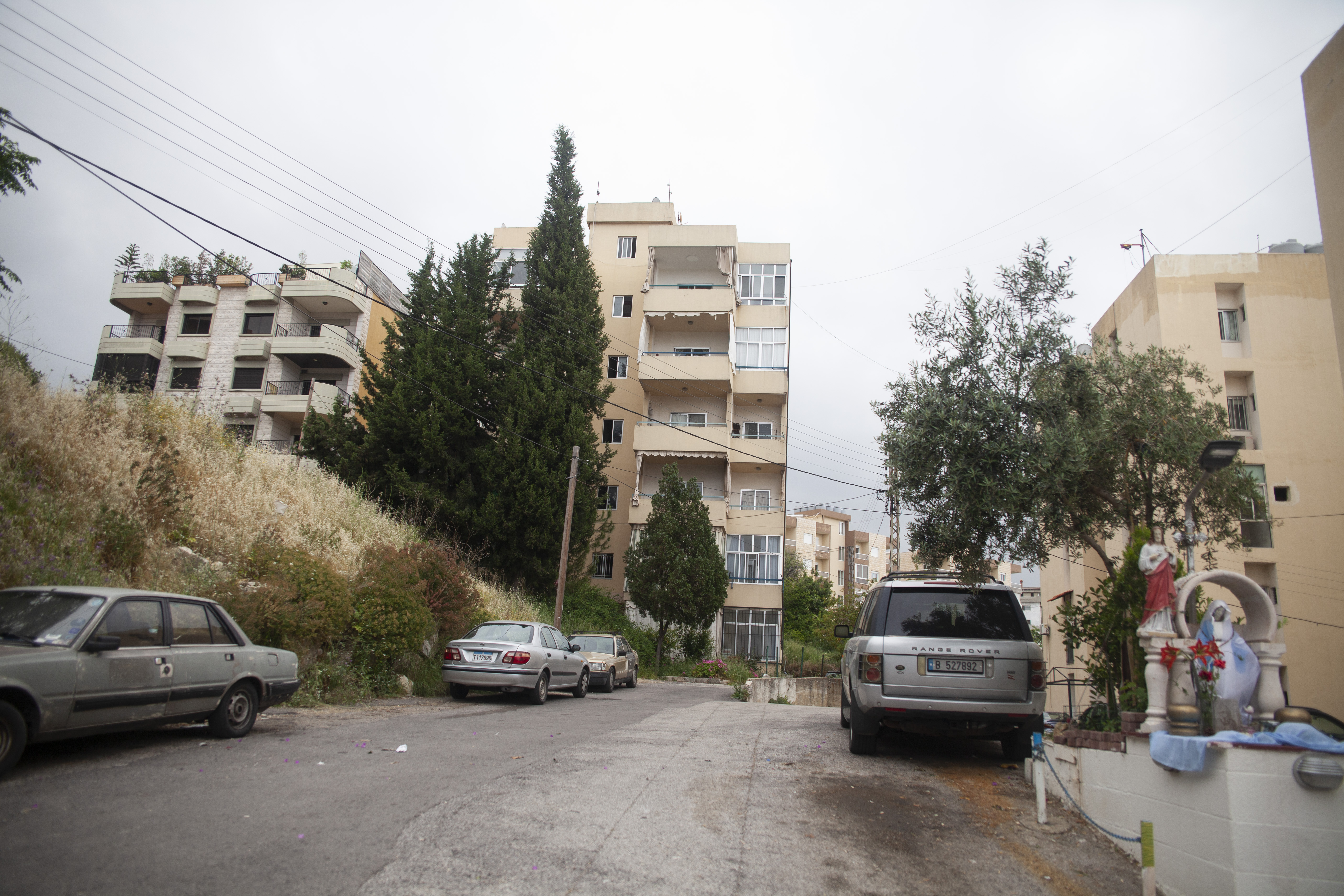 A photo of a road with buildings and cars.