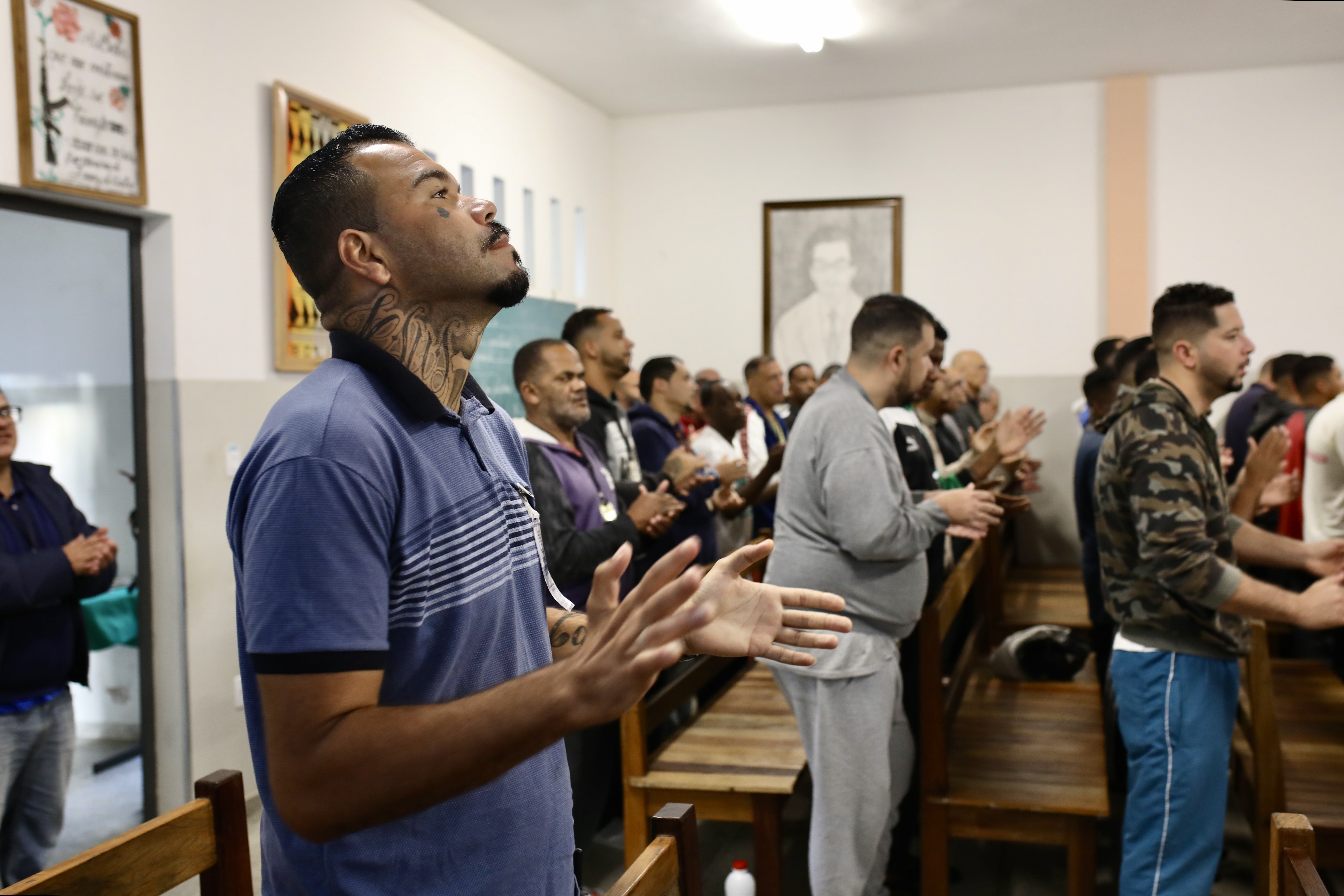 Israel Domingos claps during a spiritual gathering in Apac prison