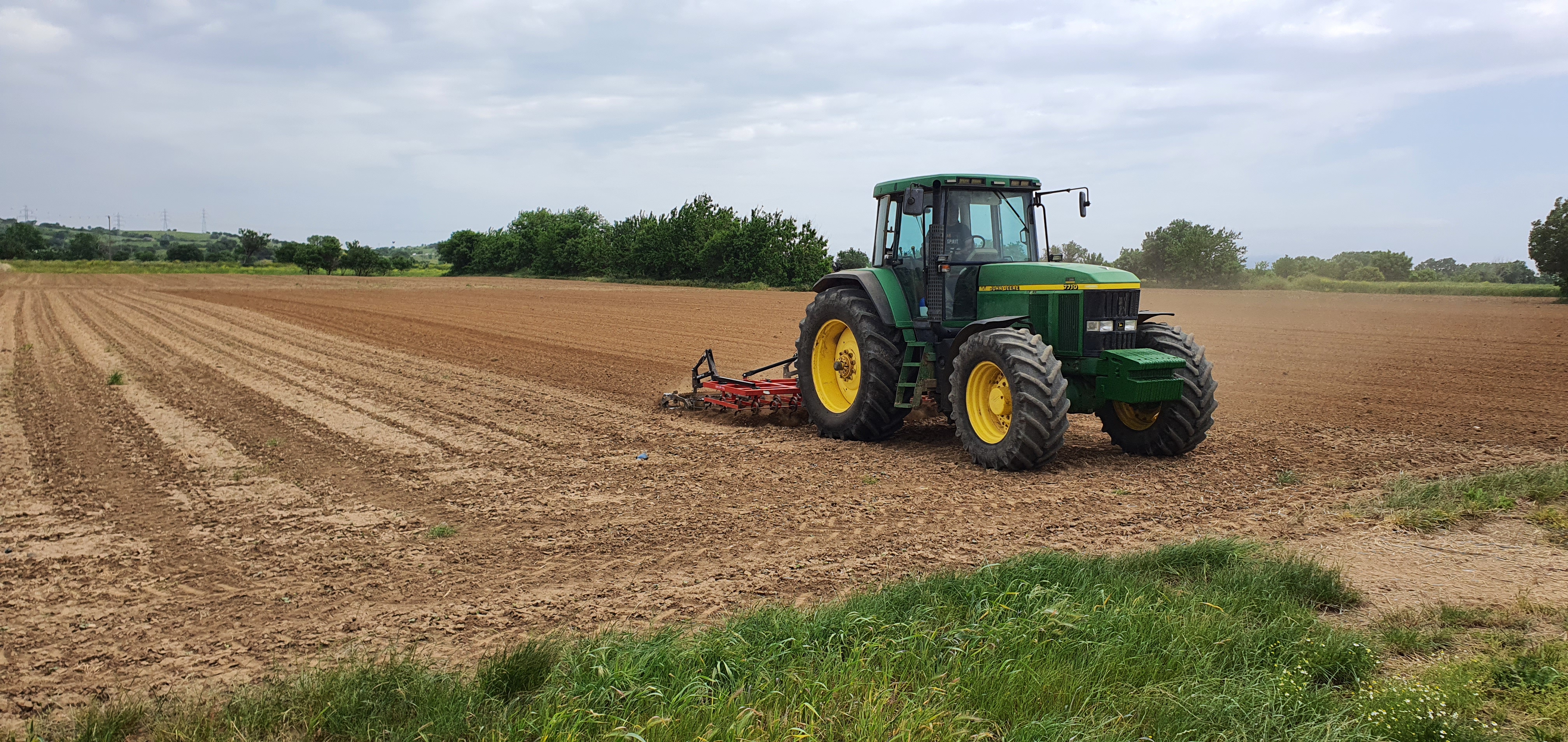 A farmer breaks up hard topsoil caused by unseasonal rain, which prevented his cotton seed from sprouting, in Alexandroupolis, northern Greece 