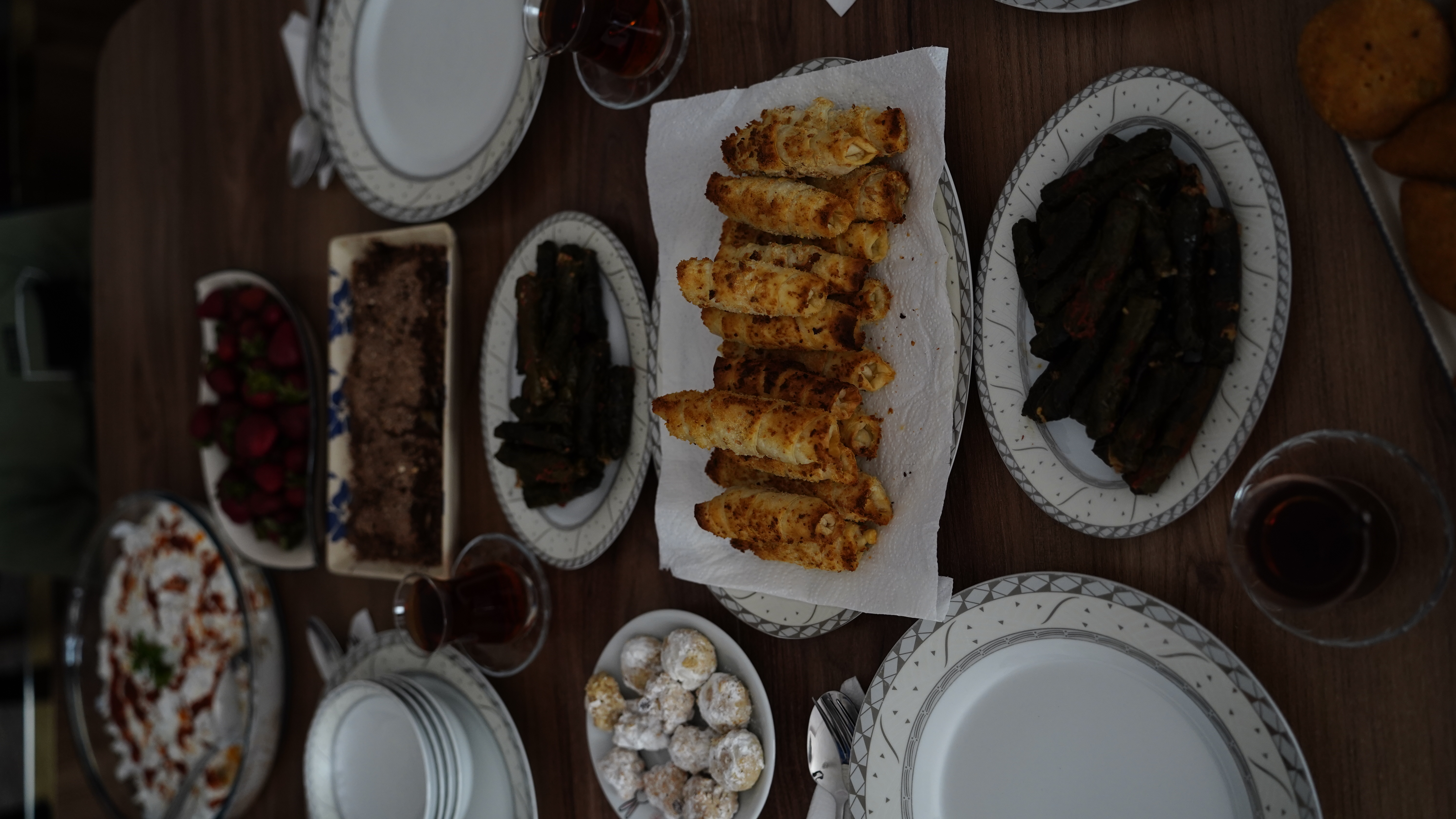 Latife, who loves hosting guests, has prepared a table with Turkish delicacies such as manti, borek, stuffed vine leaves, baklava, and tea