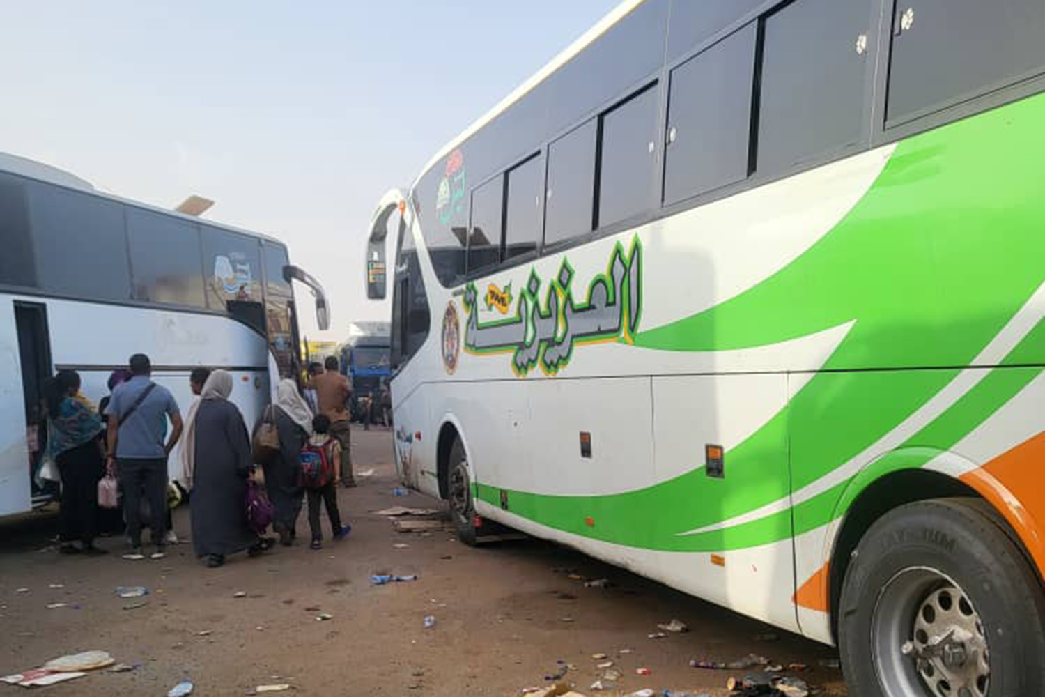 Passengers boarding a bus at the Argeen border crossing for a journey to Aswan, Egypt, April 29, 2023 [Courtesy of Tibyan Farid]