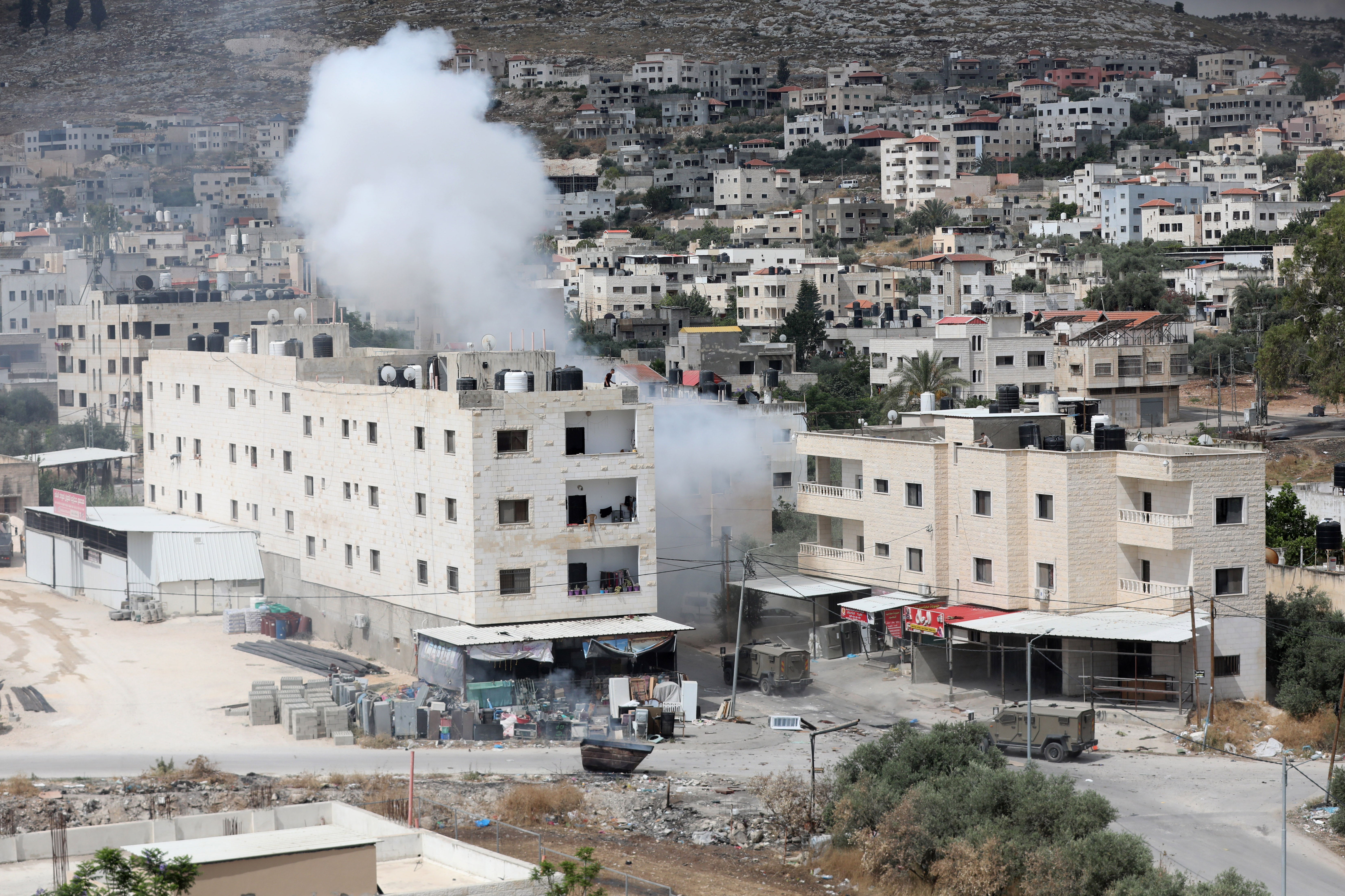Smoke billows from an explosion during an Israeli army raid in the occupied West Bank city of Jenin