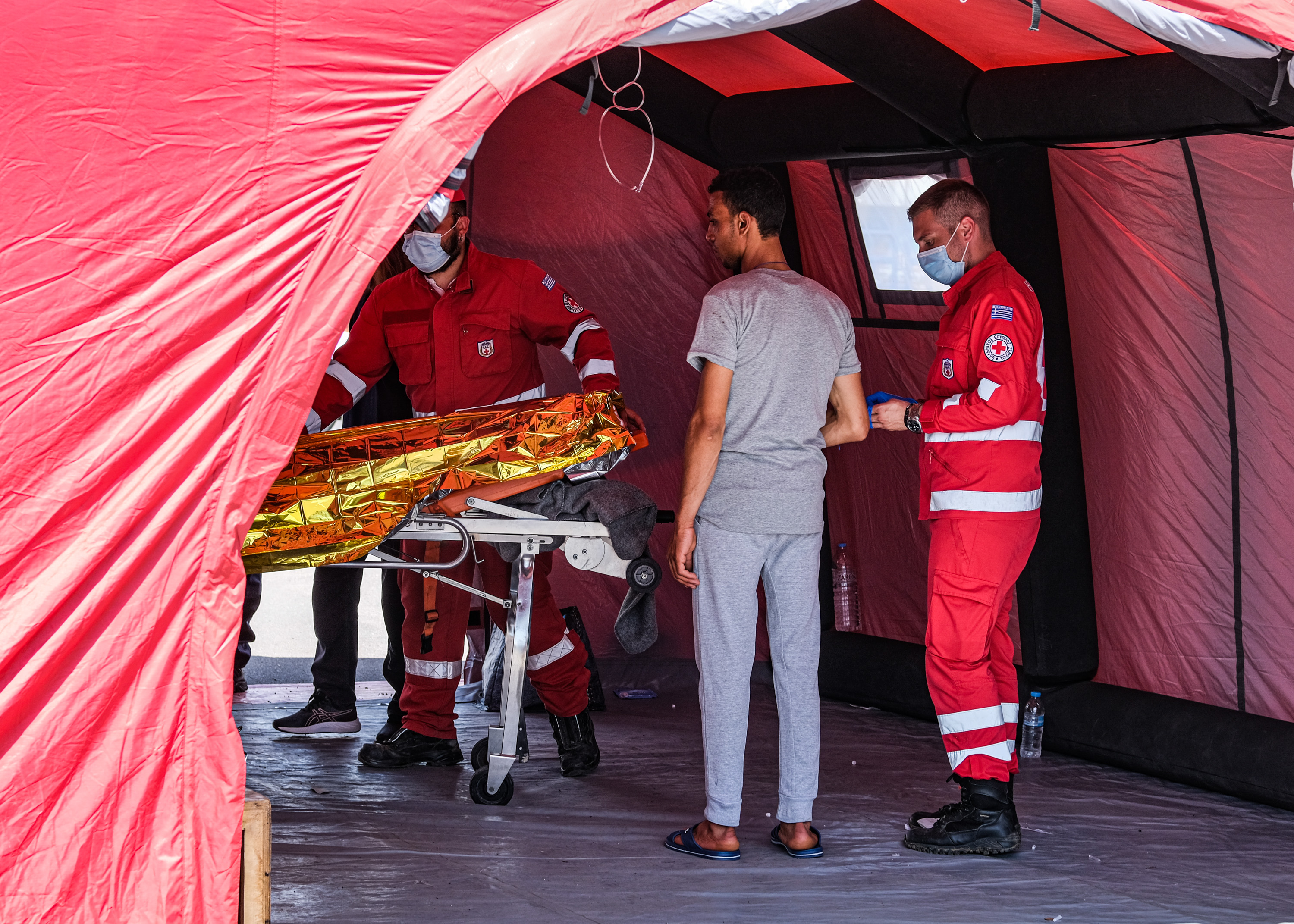 A migrant who survived the capsized boat receives medical care June 15, 2023 in Kalamata, Greece. A fishing boat carrying hundreds of passengers attempting to reach Europe capsized and sank off Greece on June 14, leaving at least 79 dead and many more missing in one of the worst disasters of its kind in the past decade. Greece declared a three-day national mourning period for the victims of the shipwreck of its southern coast on June 14. (Photo by Byron Smith/Getty Images)