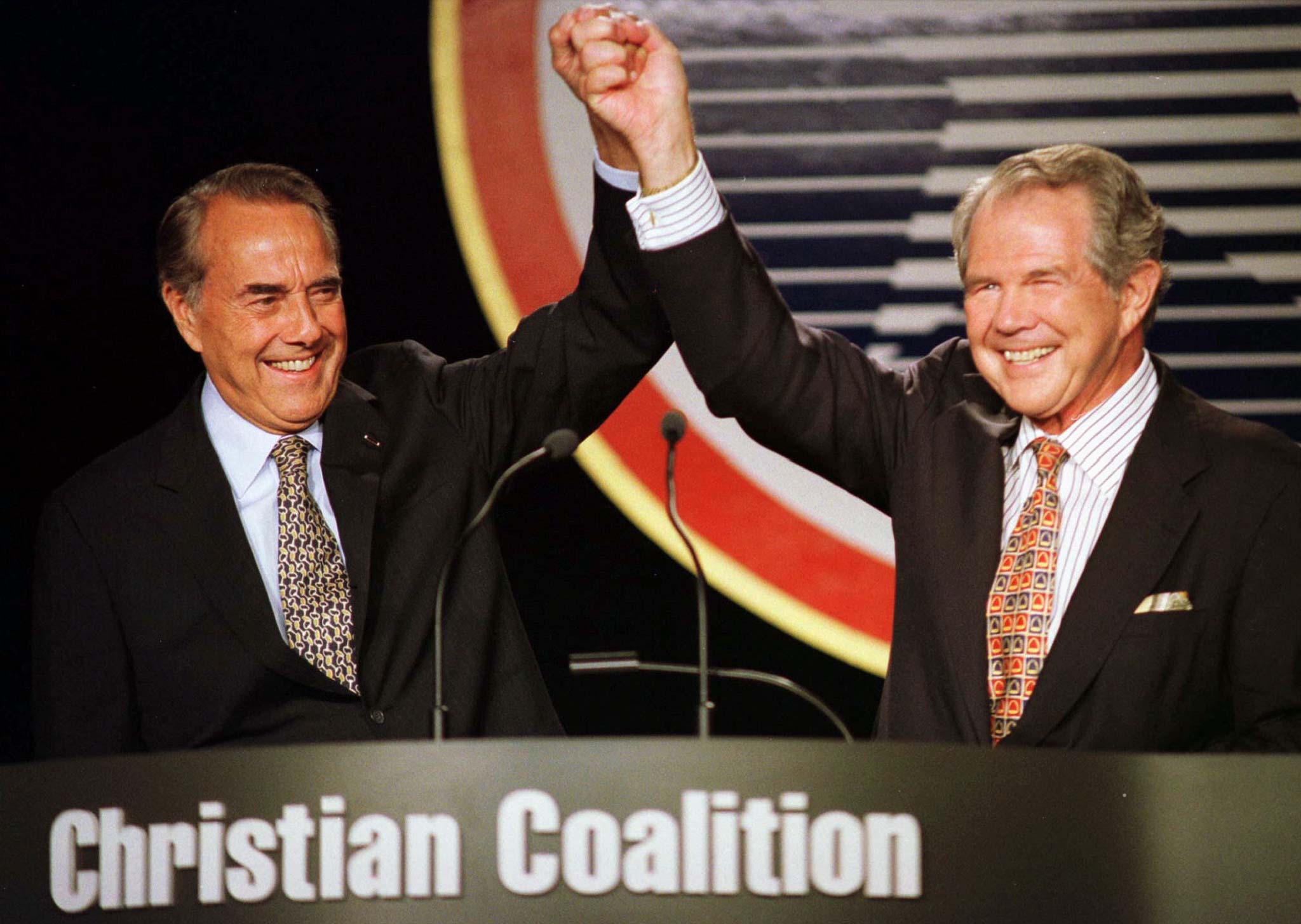 Republican presidential nominee Bob Dole (L) greets Christian Coalition supporters with coalition founder Pat Robertson