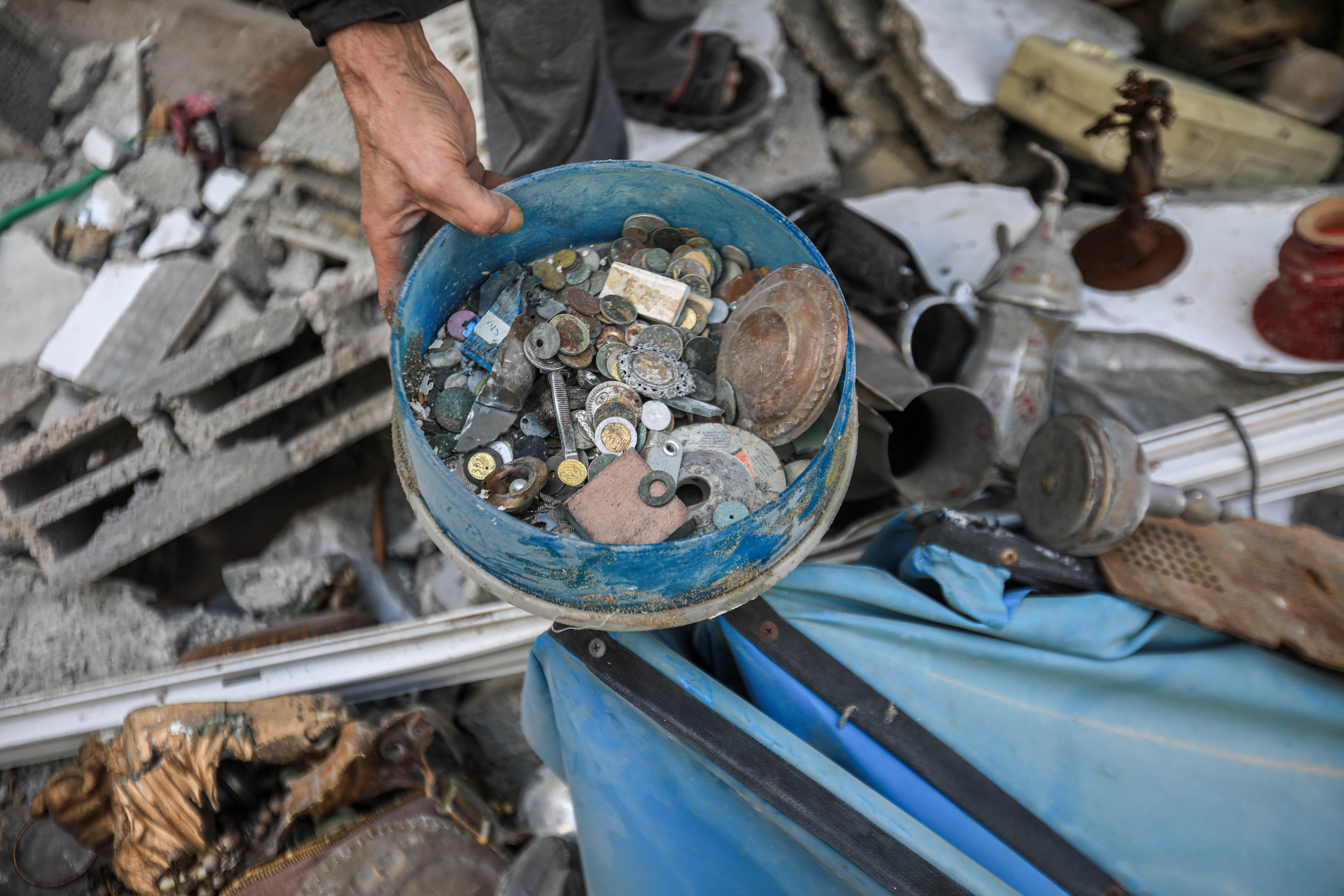 Old coins and artifacts that Hazem Mohanna collected from under the rubble of his house, which was bombed on May 12