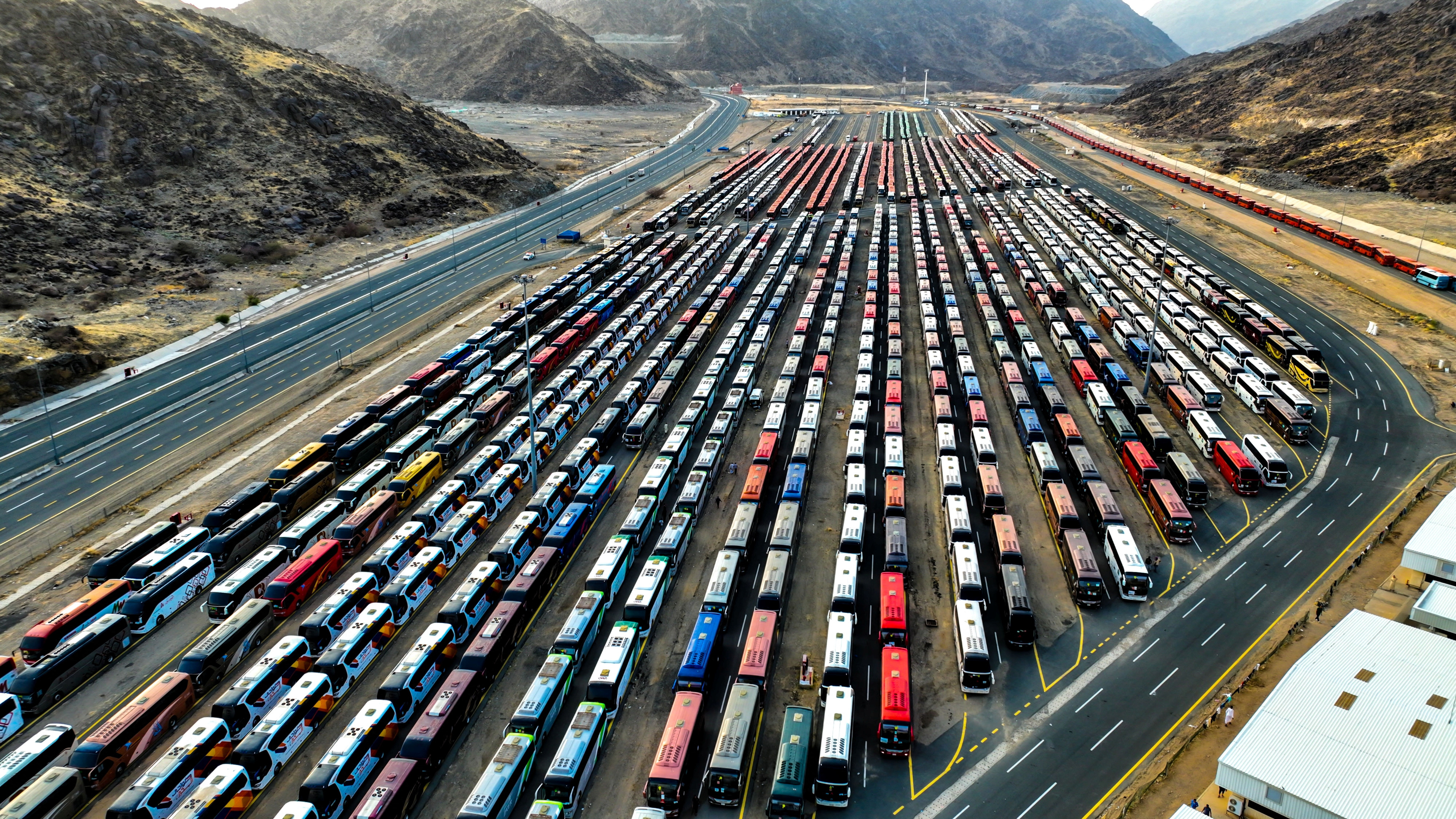 A general view shows busses parked at the outskirts of the holy city of Mecca, ready to transport people