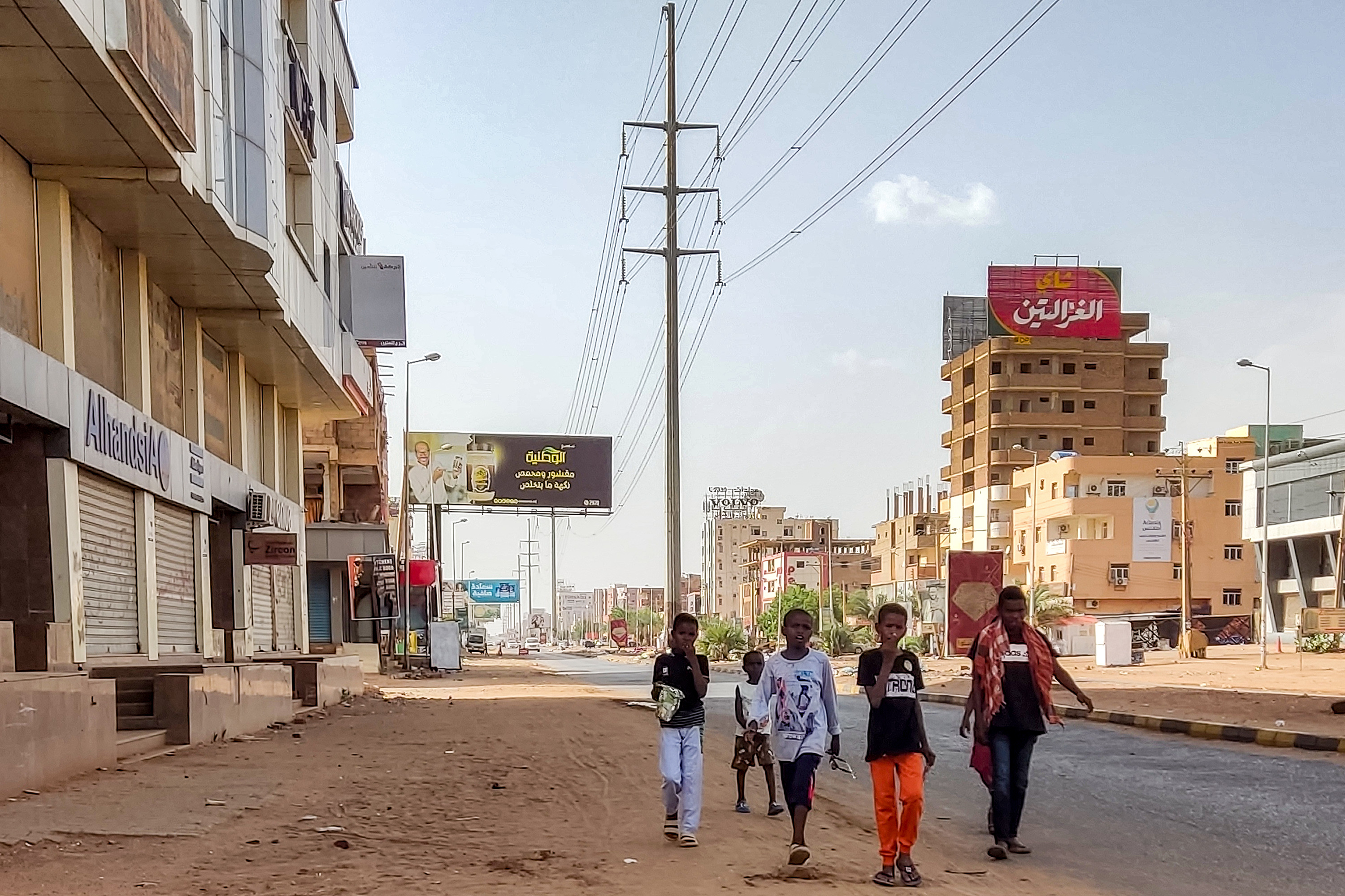Children walk along the side of a street