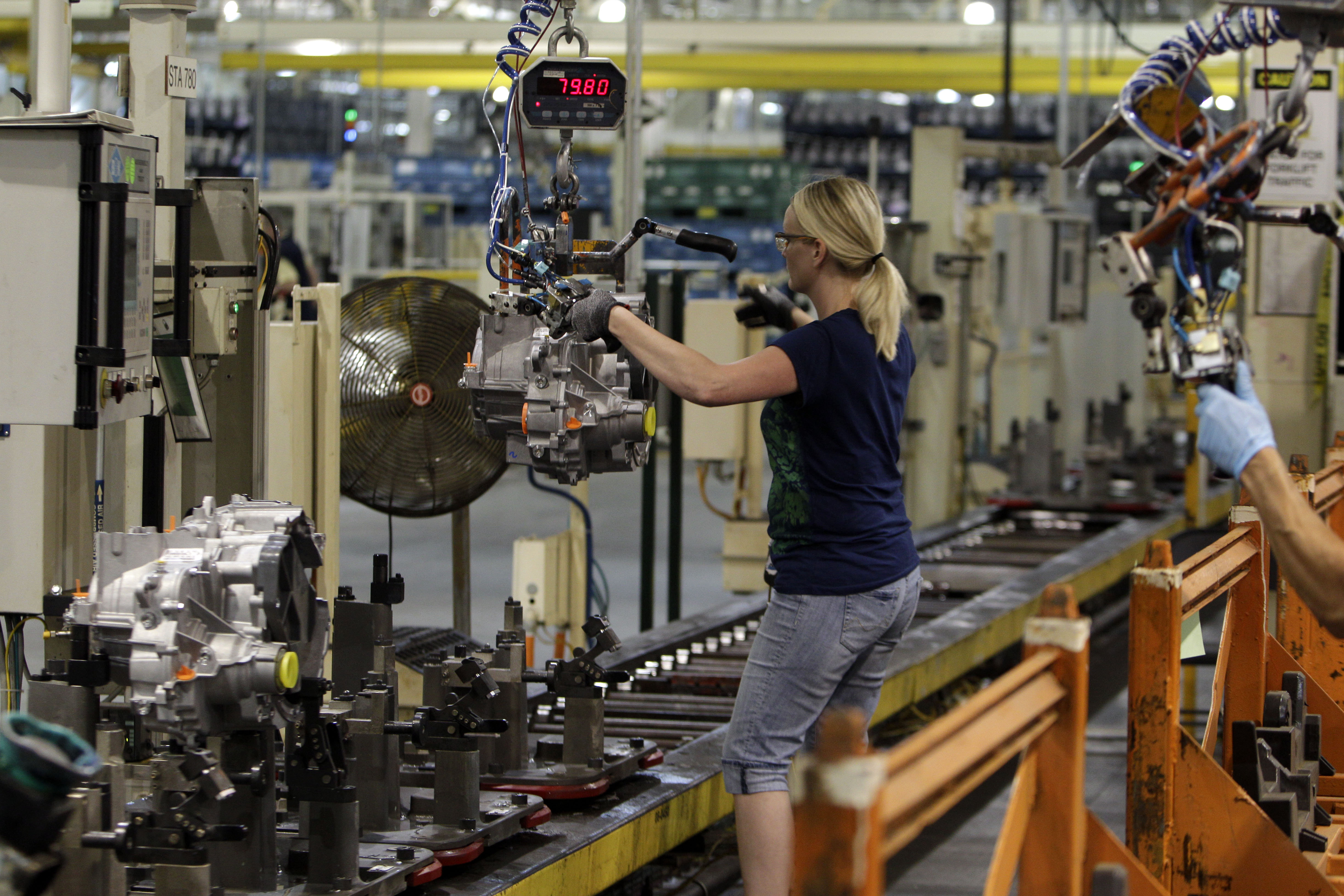 Line worker Cheryl Simpson moves a transmission from the assembly line to a pallet at the Ford Van Dyke Transmission Plant in Sterling Heights, Michigan, US