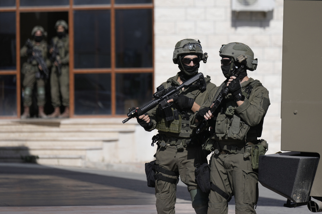 Israeli soldiers search in the West Bank village of Qafin for the suspected gunmen who shot and killed an Israeli civilian near the entrance to a Jewish settlement of Hermesh, Tuesday, May 30, 2023. (AP Photo/Majdi Mohammed)