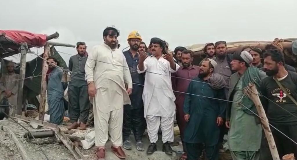 Rescue officials and residents are seen outside the coal mine in Balochistan province