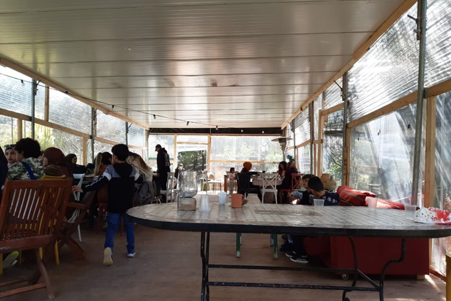 a covered seating area in the garden-restaurant