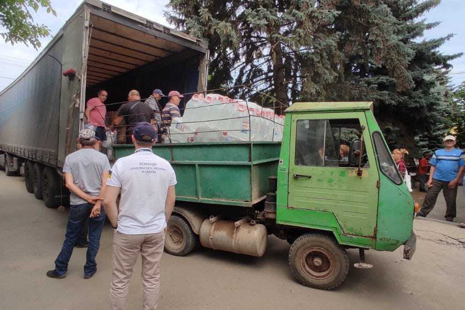 Drinking water is delivered under the near-constant sound of shelling