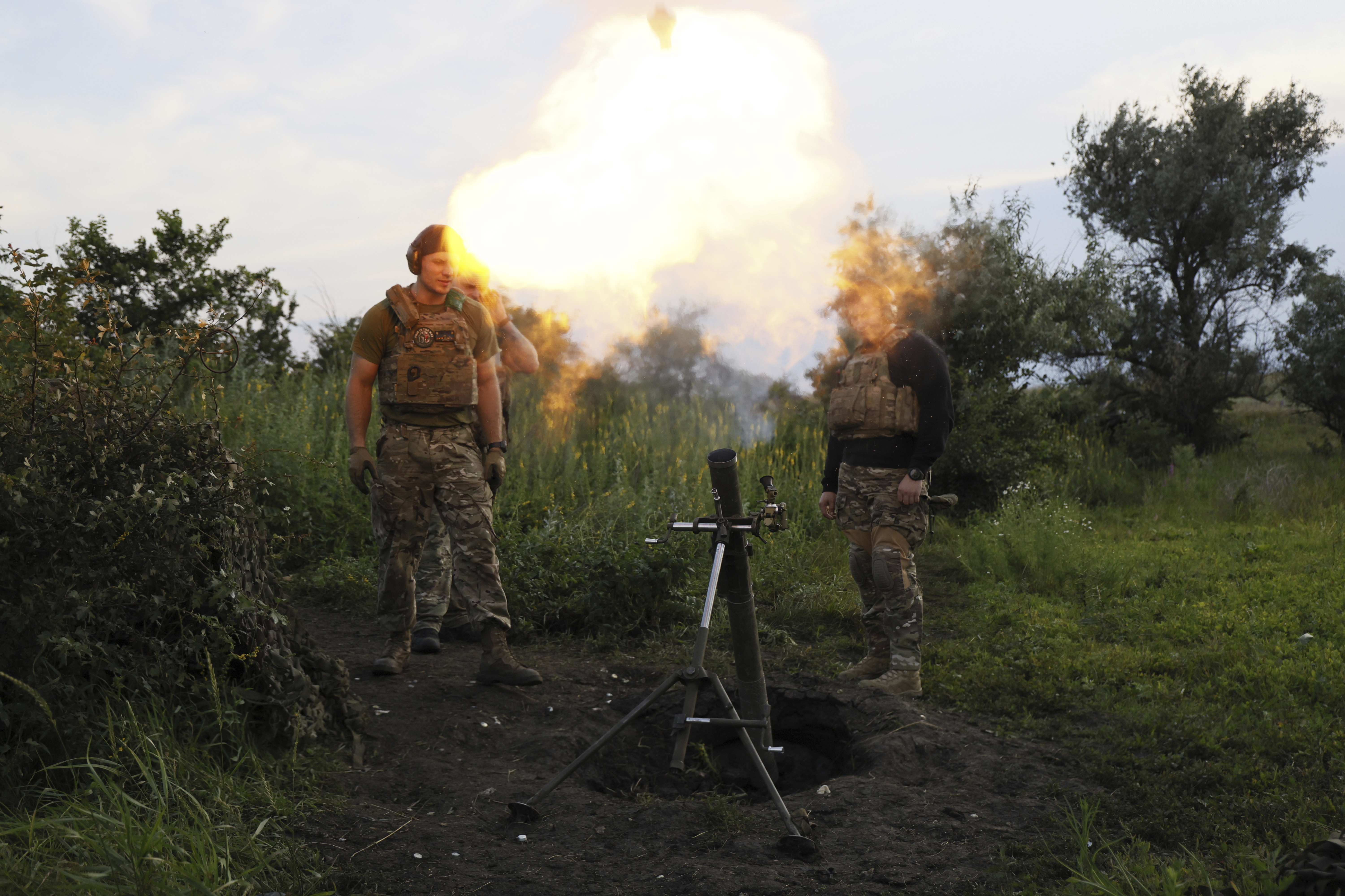 Ukrainian servicemen of the 3rd separate assault brigade fire a 82mm mortar towards Russian positions at the front line, near Bakhmut, Donetsk region