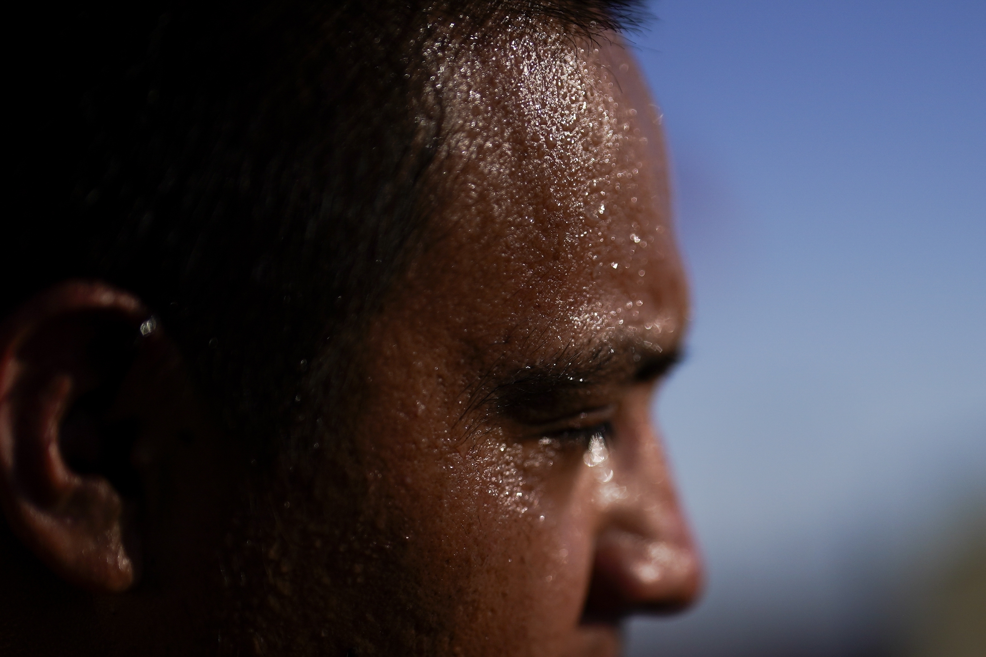 Sweat covers the face of Juan Carlos Biseno after dancing