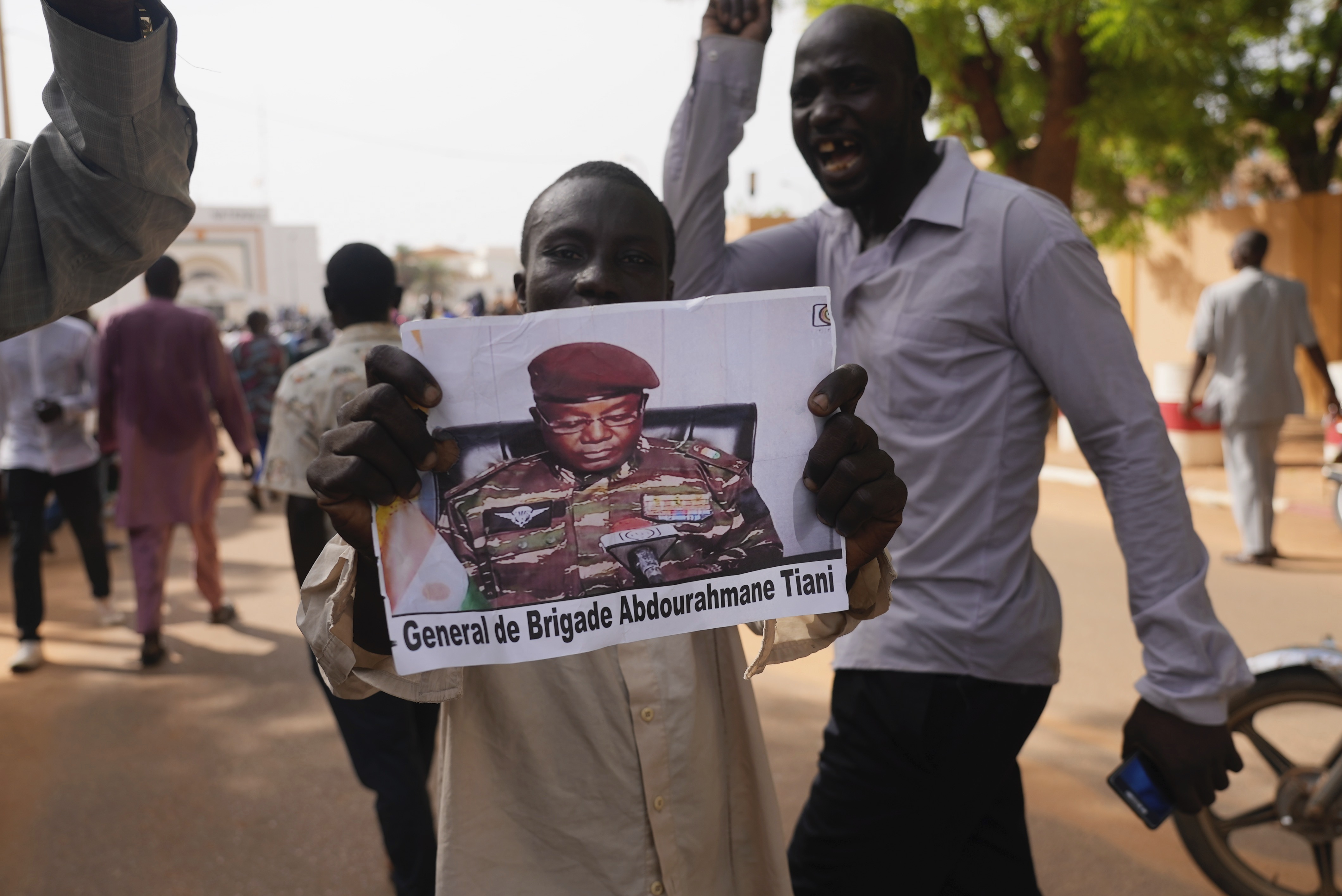 Nigeriens participate in a march called by supporters of coup leader Gen. Abdourahmane Tchiani,