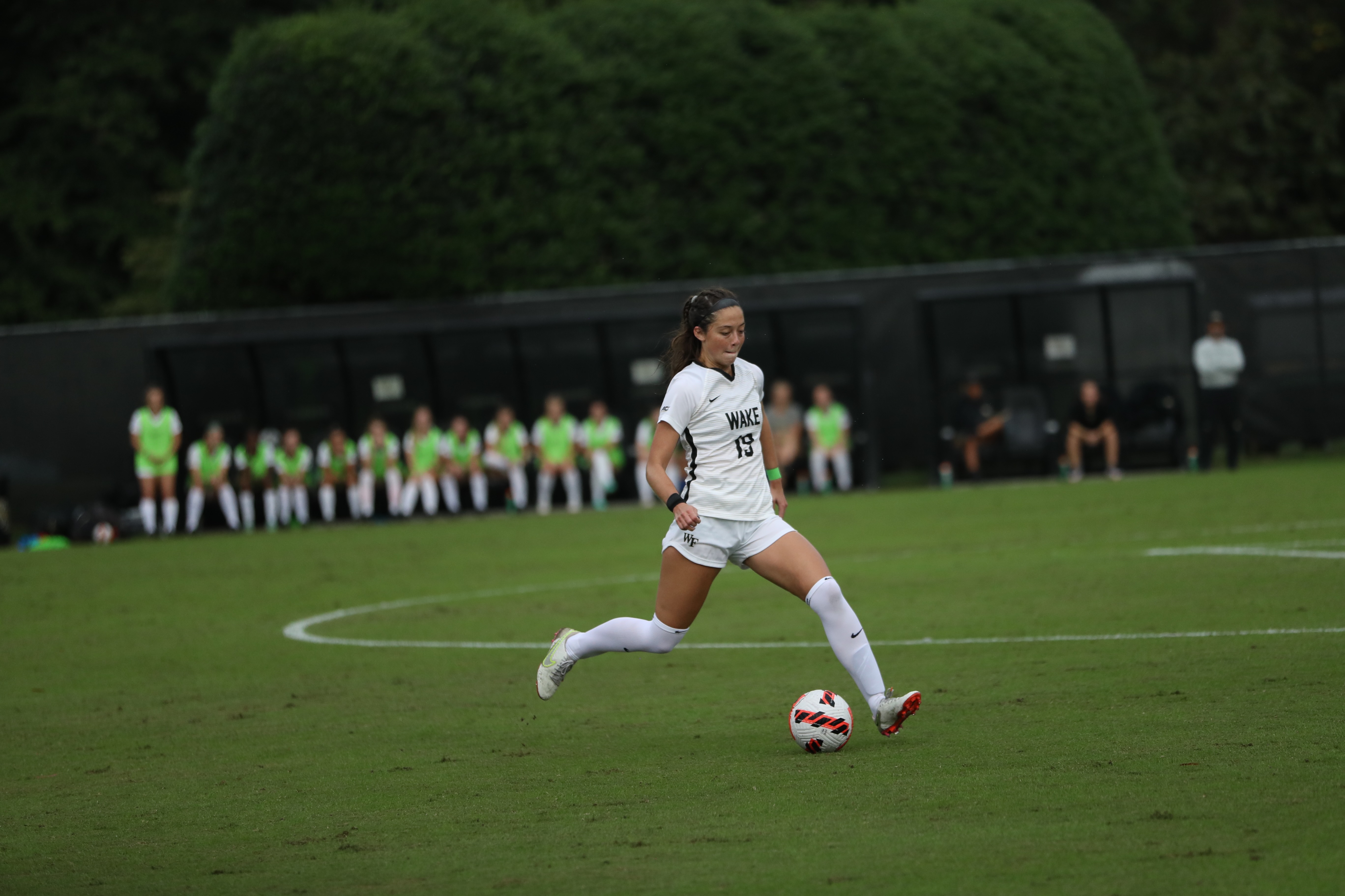 US football player Lyndon Wood dribbles a ball during a game for Wake Forest University