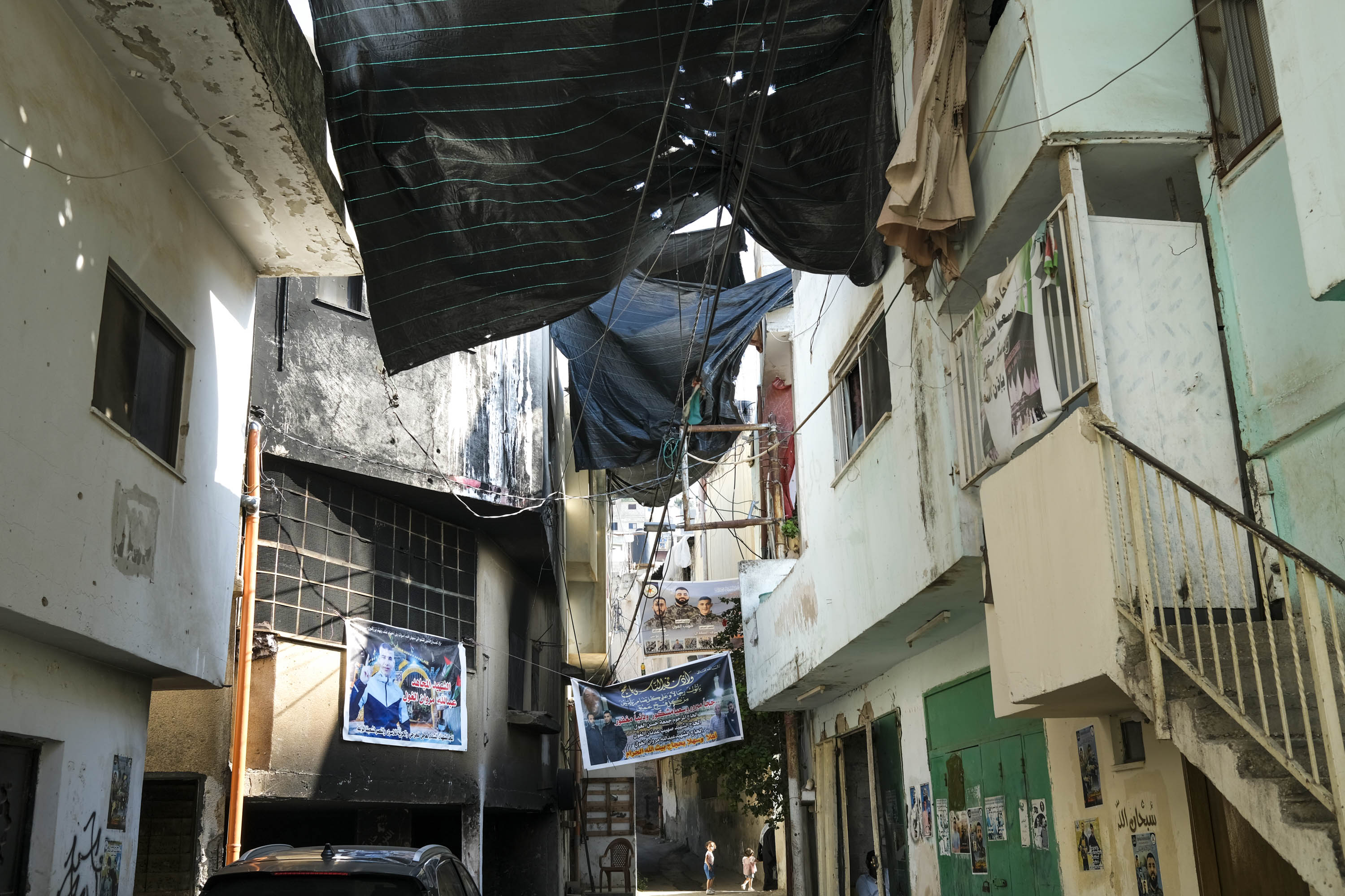 2 - Jenin camp is a spiderweb of tight alleyways and dilapidated buildings whose walls are often covered with supersized banners bearing the portraits of “martyrs” [Virginia Pietromarchi/Al Jazeera]
